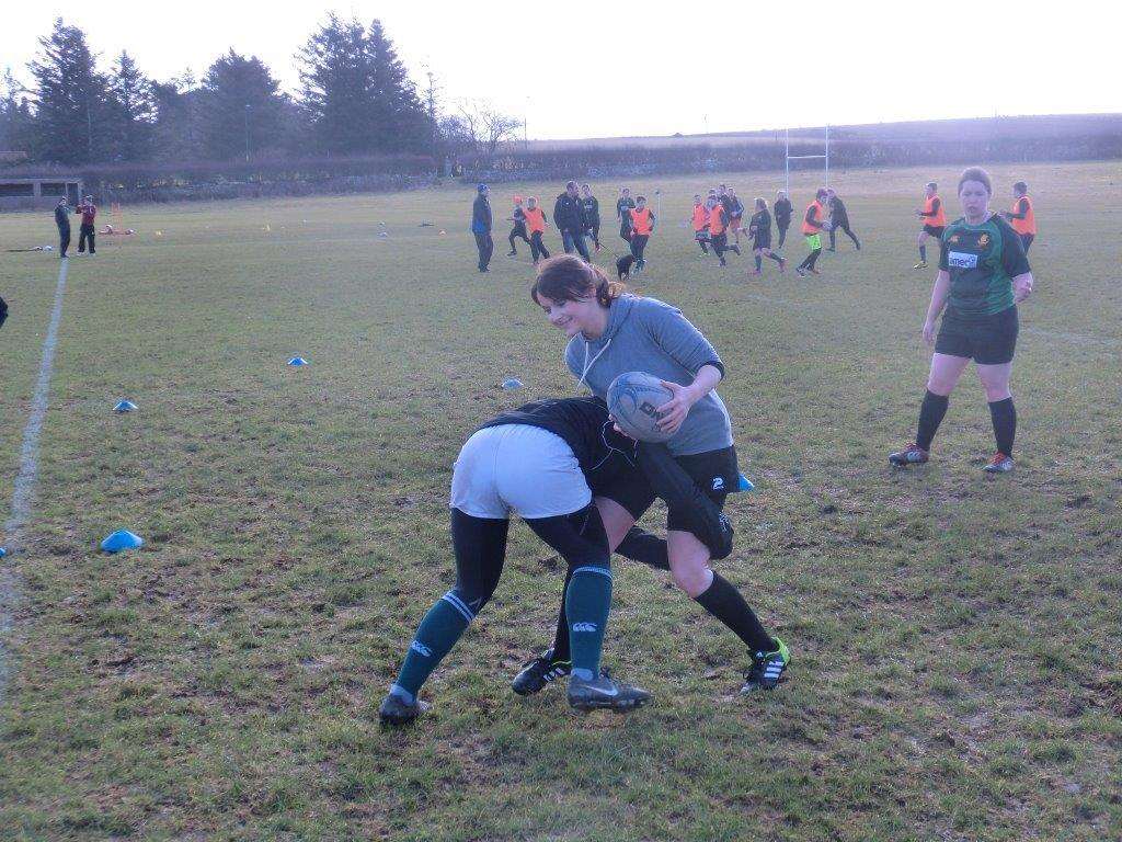 Madison Innes takes the impact of a tackle during training.