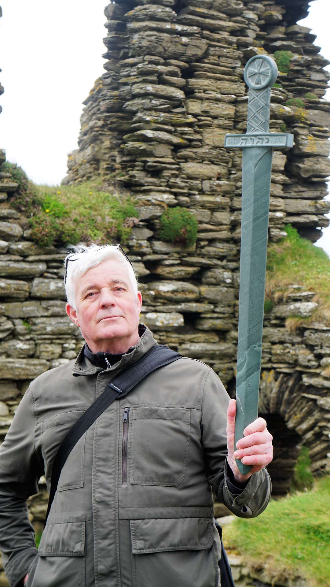 Questus author Shawn Williamson holds the stone sword he sculpted that will feature in the production. Picture: DGS