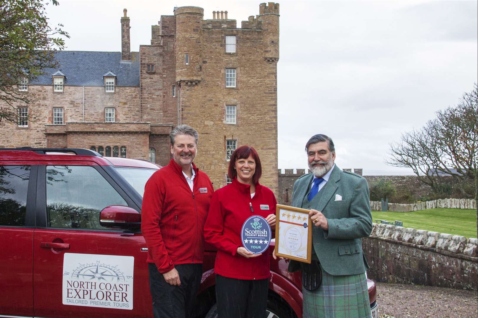 VisitScotland chairman Lord Thurso presenting the quality assurance award to Robert and Sally-Ann James of North Coast Explorer Tours.