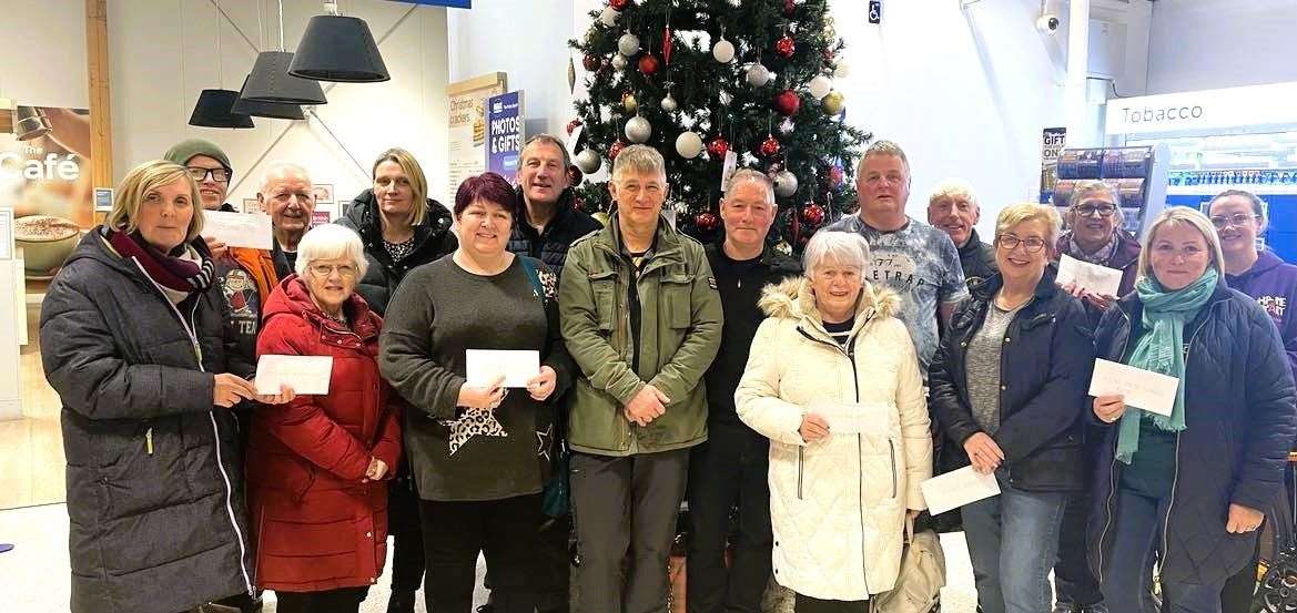 Cheques are handed over by the Friends of Tender group at Wick Tesco. Middle, from left: Neil Pellow (back-up driver), Davie Oman, Willie MacDonald and Arthur Bruce, pictured with representatives of some of the groups who benefited from the cycle. Picture supplied