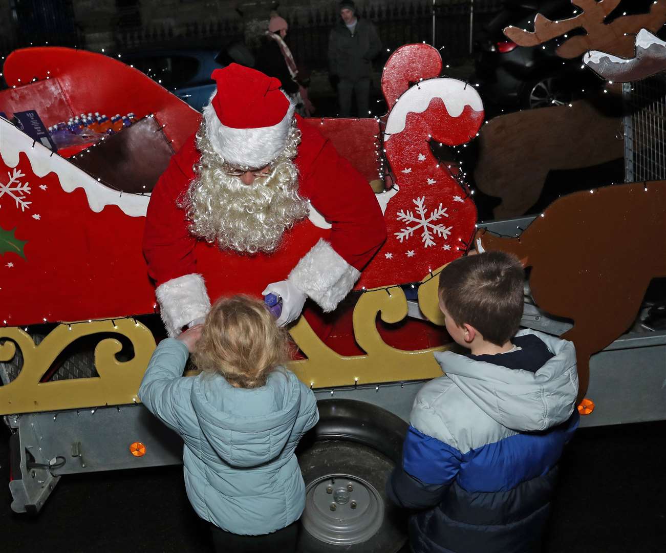 Santa hands out sweets and bottled drinks. Picture: James Gunn