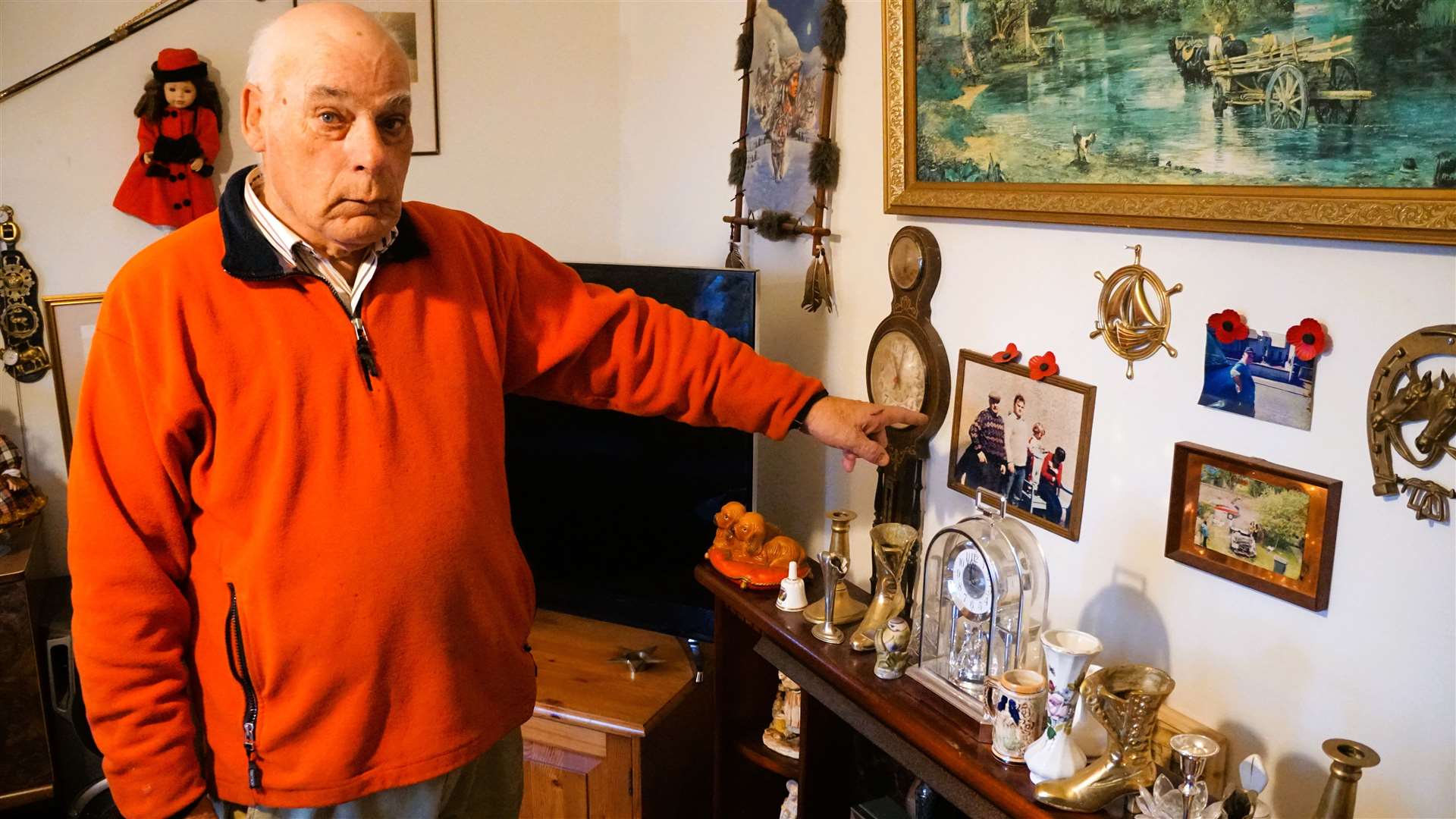 The 69-year-old shows family pictures and other keepsakes on the wall of his house. He says he will throw everything out and live in his van. Picture: DGS