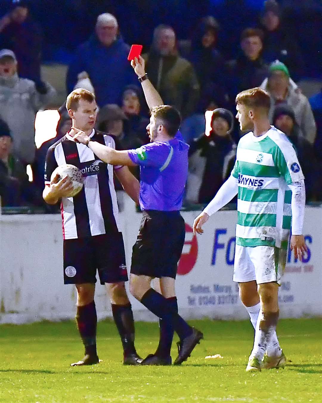 Wick Academy's Owen Rendall looks perplexed as referee Harry Bruce brandishes the red card at Victoria Park on Saturday. Picture: Mel Roger