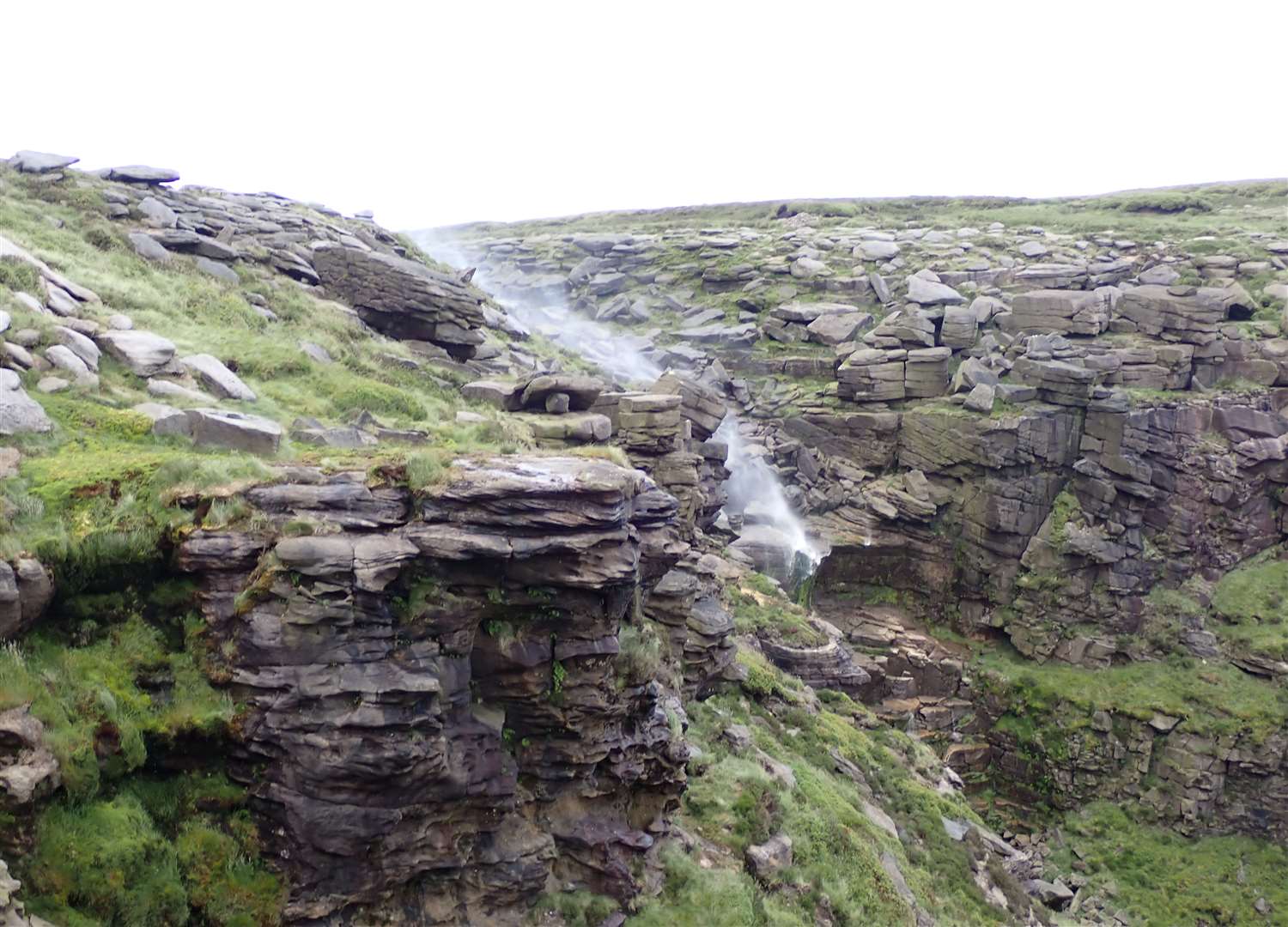 Kinder Downfall being blown back up the hill by the wind.