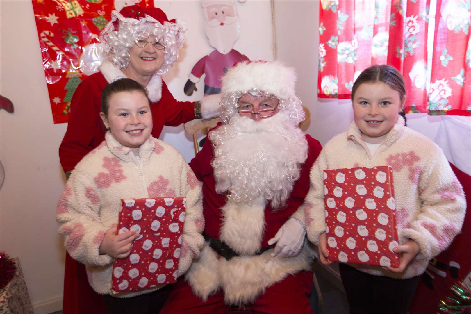 Wick twins Orla (left) and Isla Budge with Santa and Mrs Claus. Picture: Robert MacDonald / Northern Studios