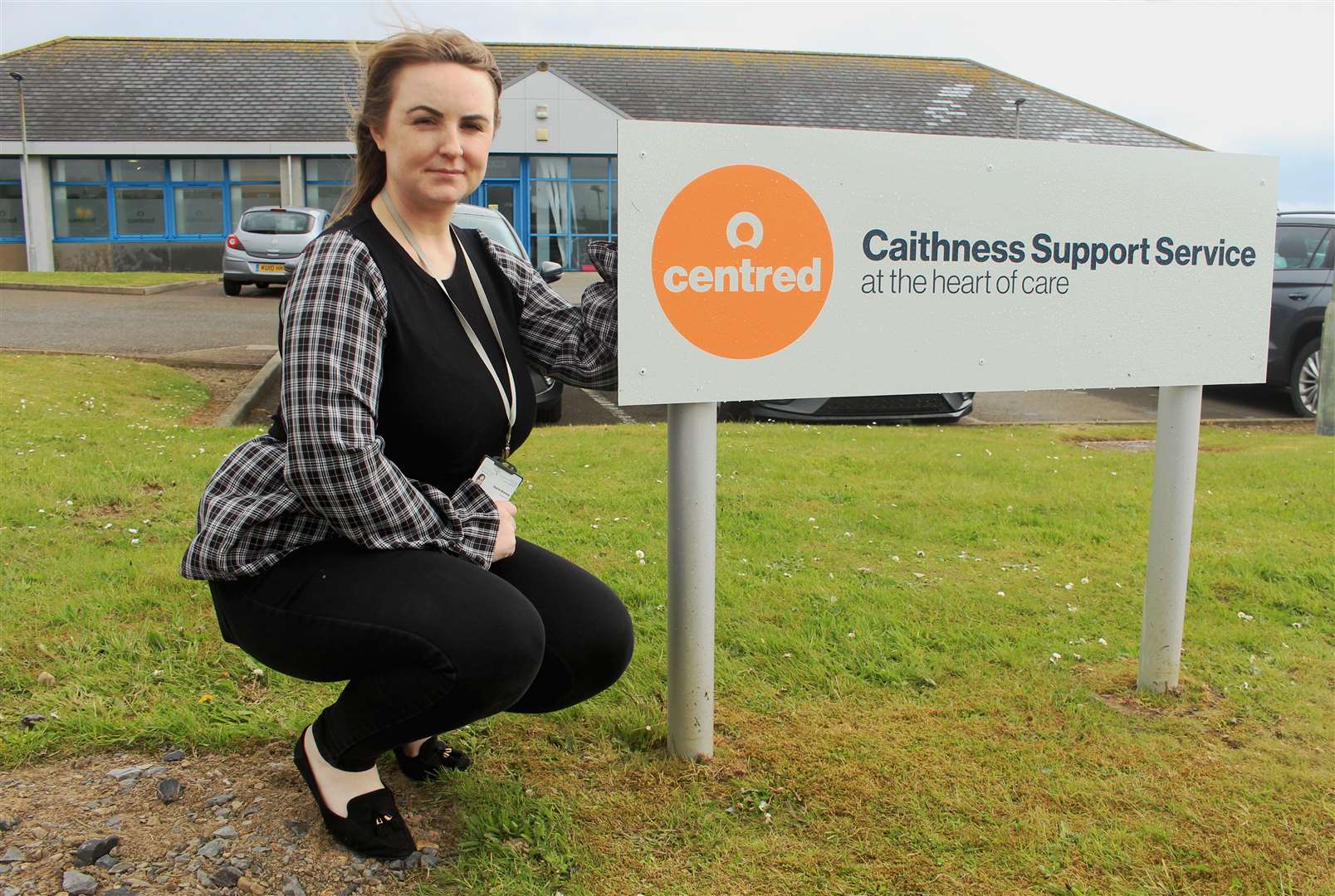 Sophie Bramley, the Wick-based health and social team manager, beside the new sign reflecting the change of brand to Centred.