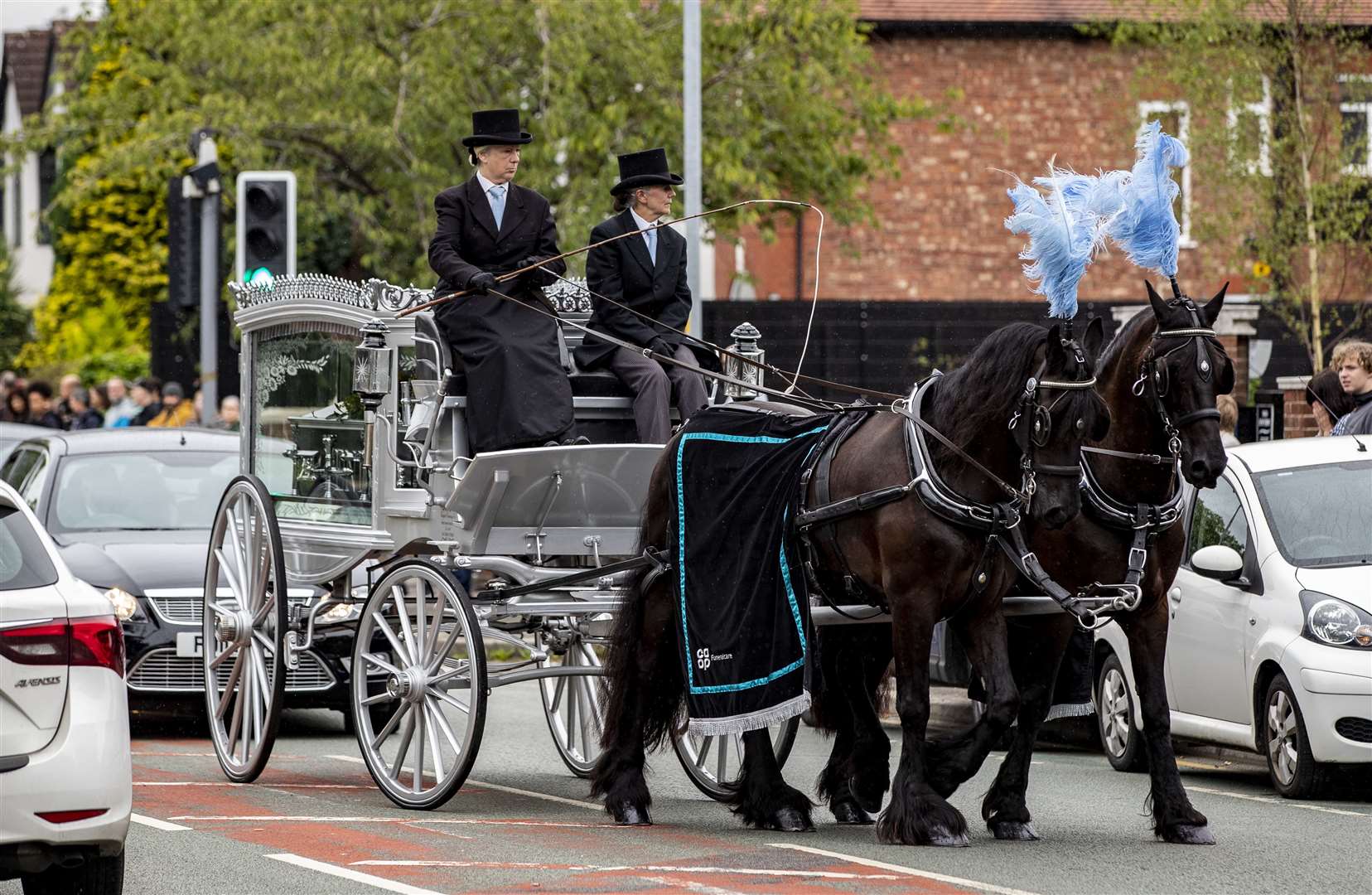 The coffin was carried in a silver carriage pulled by two horses (Peter Byrne/PA)