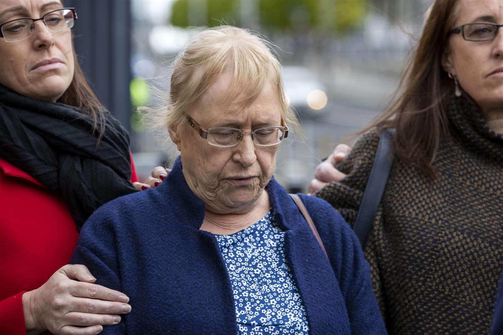 Joe McCann’s widow Anne (centre), is comforted by her daughters Nuala (left) and Aine (right) outside Belfast Crown Court (Liam McBurney/PA)