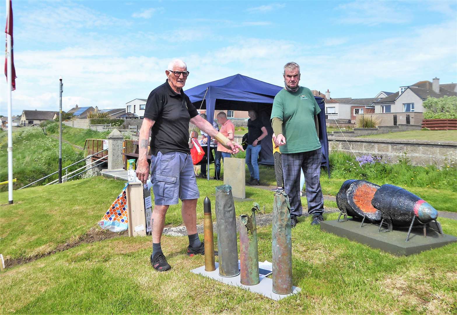 Denny Swanson, left, and fellow volunteer Derek Bremner point out the shell casing recovered from the North Baths and displayed during Saturday's Doors Open Day at the North Head pillbox. Pictures: DGS