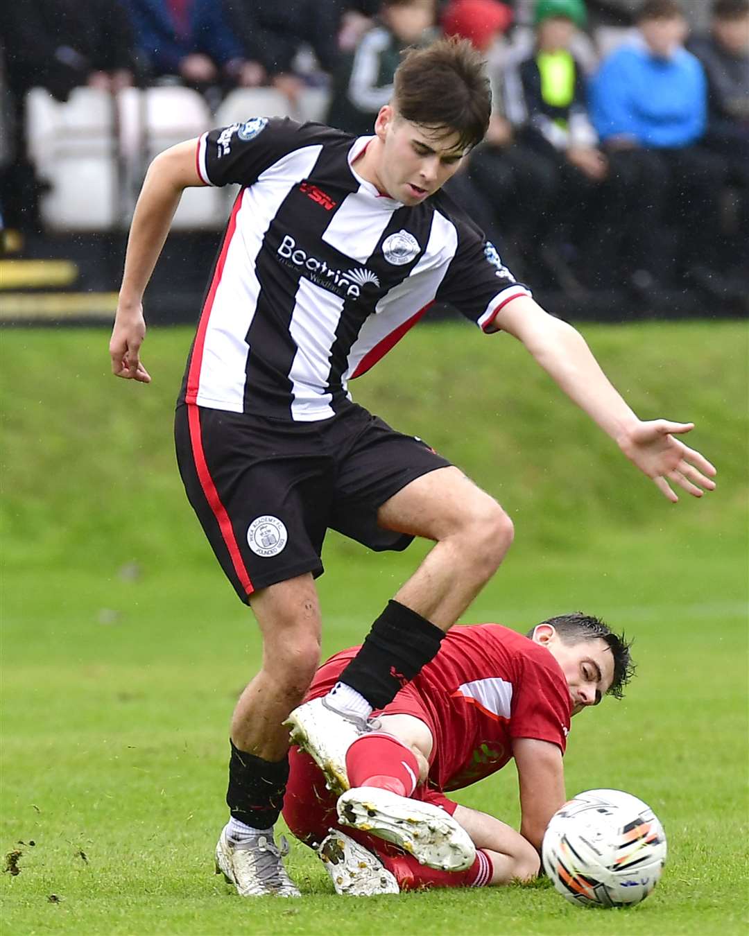 Lossiemouth's Liam Archibald stretches out a leg to stop Gary Pullen of Wick Academy. Picture: Mel Roger