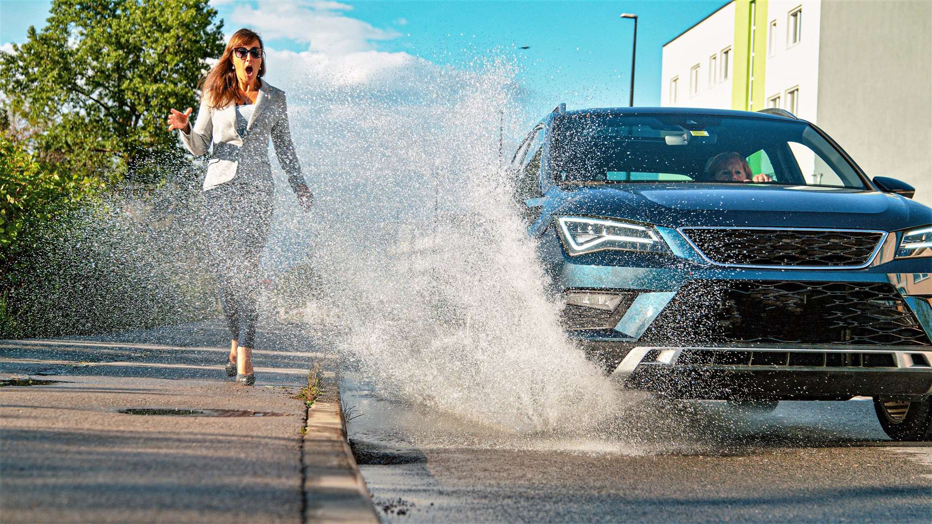 Woman is shocked as she gets splashed with water by reckless driver. Picture: Adobe