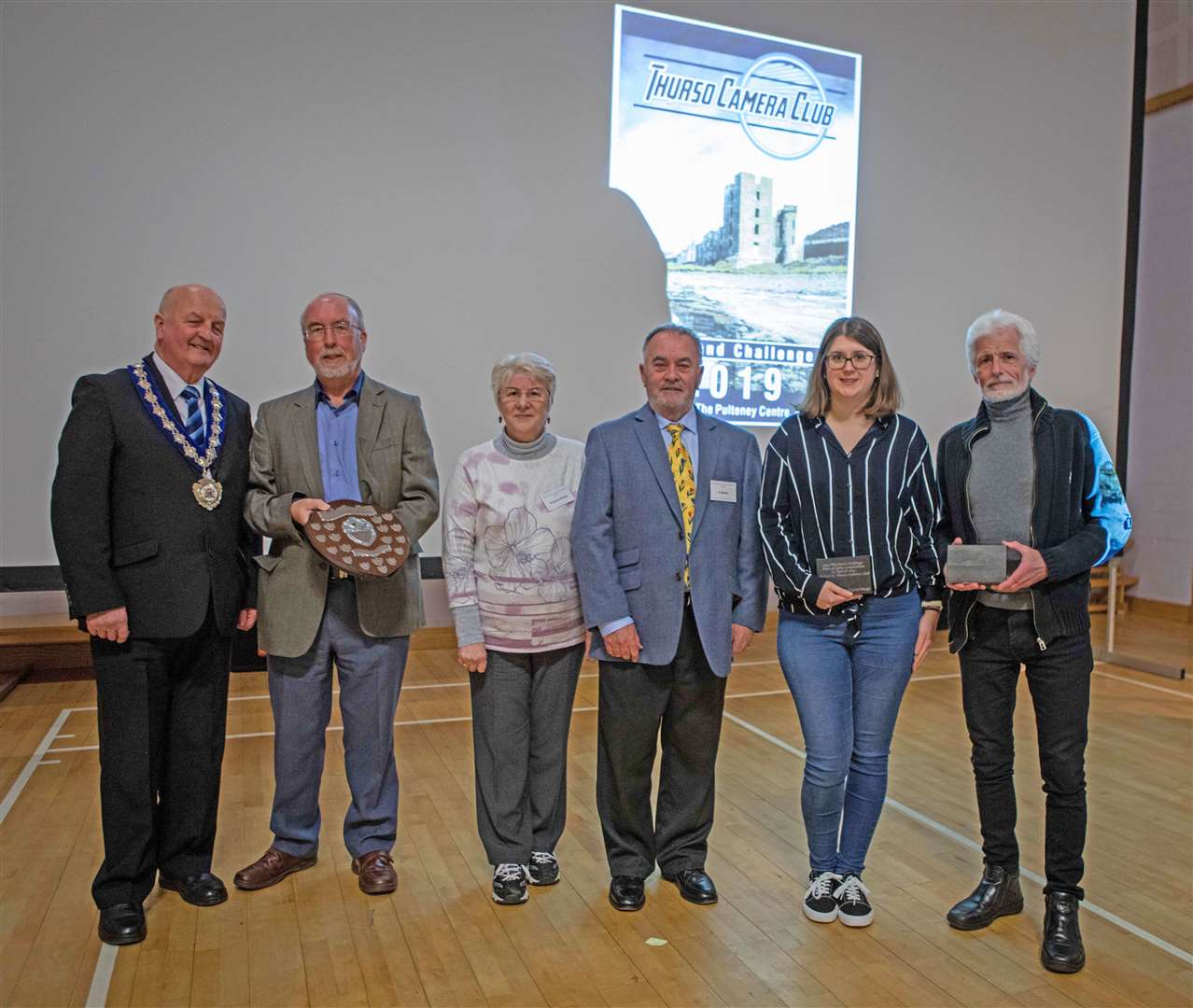 The winner of the Highland inter-club challenge, Phil Downie of Dingwall, and the individual class winners alongside the judge Al Buntin (centre), his wife Marjorie, who presented the prizes, and Caithness civic leader Willie Mackay, who presented his donated trophy to the winner of the best overall image.