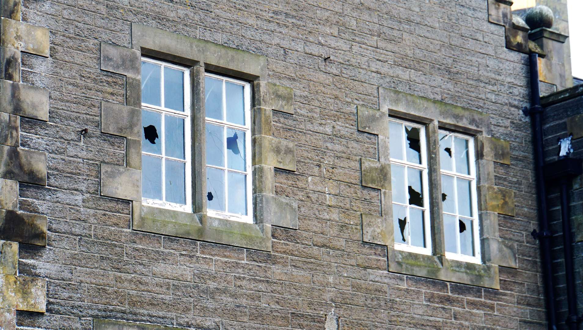 Smashed windows at the former Wick High School. The building was repeatedly targeted by vandals and the interior has been badly damaged too. Picture: DGS