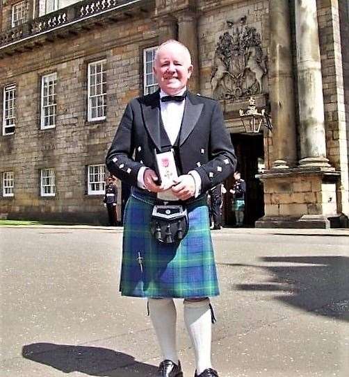 Pat with his MBE outside Holyrood Palace in 2010