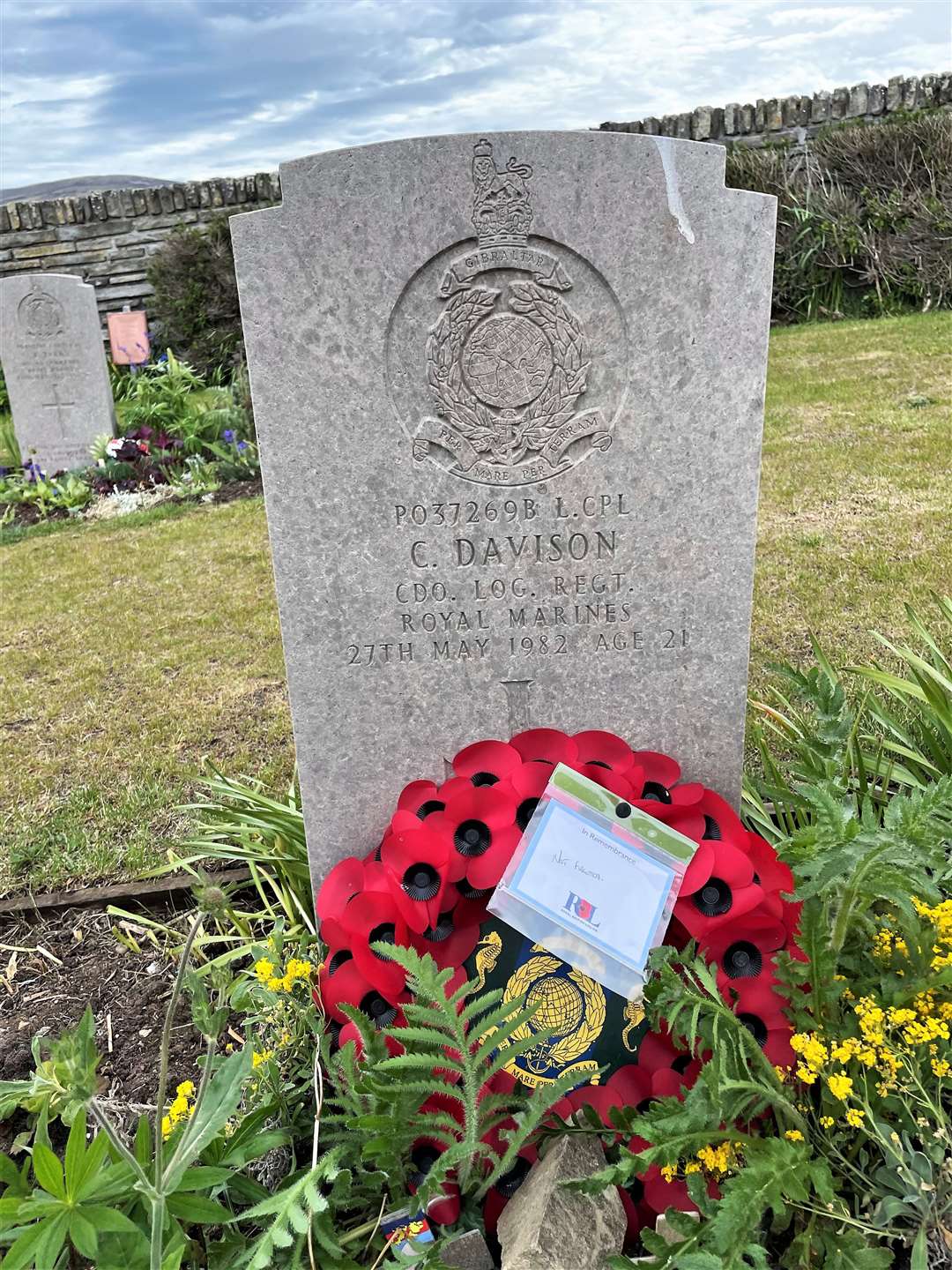 John placed a Remembrance poppy on the grave of Lance Corporal Geordie Davison's headstone at San Carlos Cemetery.