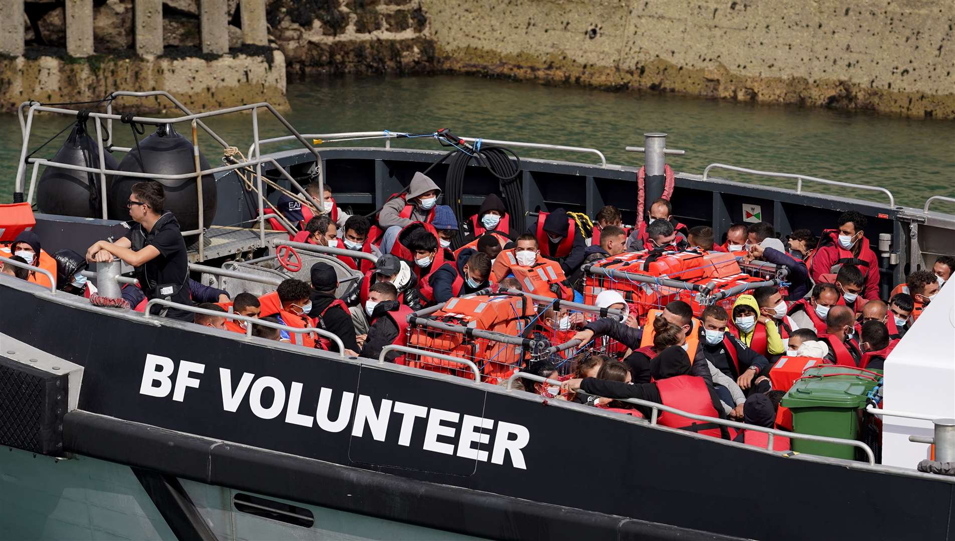 A group of people, thought to be migrants, is brought in to Dover, Kent, on board a Border Force vessel on Sunday (Gareth Fuller/PA)