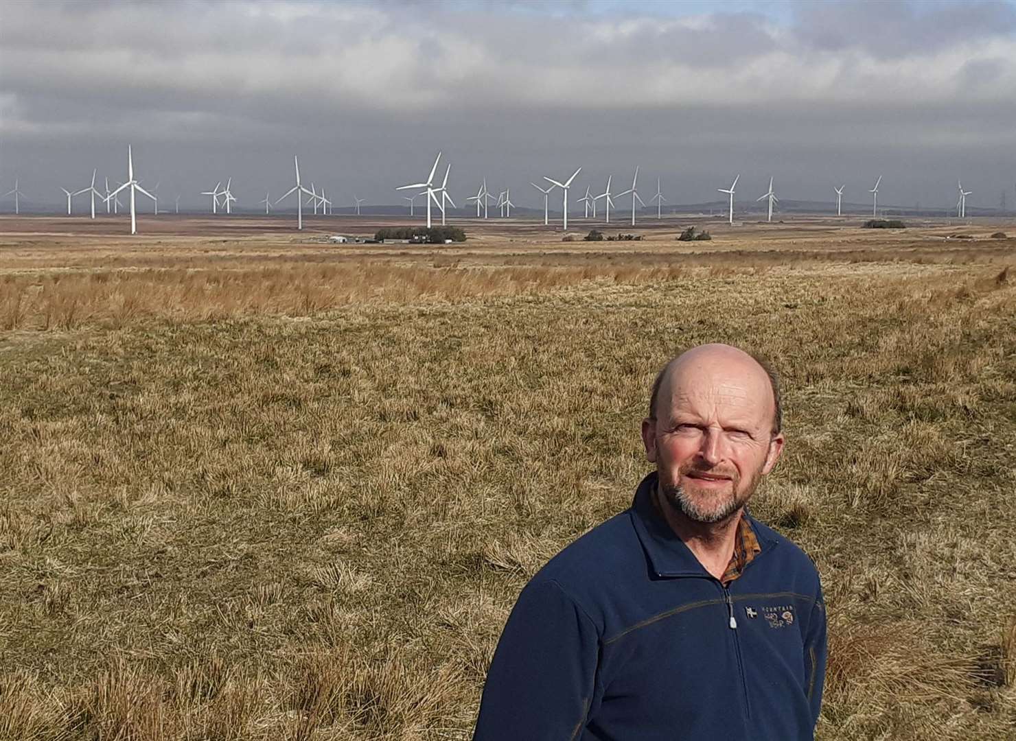 Councillor Matthew Reiss beside the Causewaymire with a cluster of wind farms in the distance. Picture: Alison Reiss