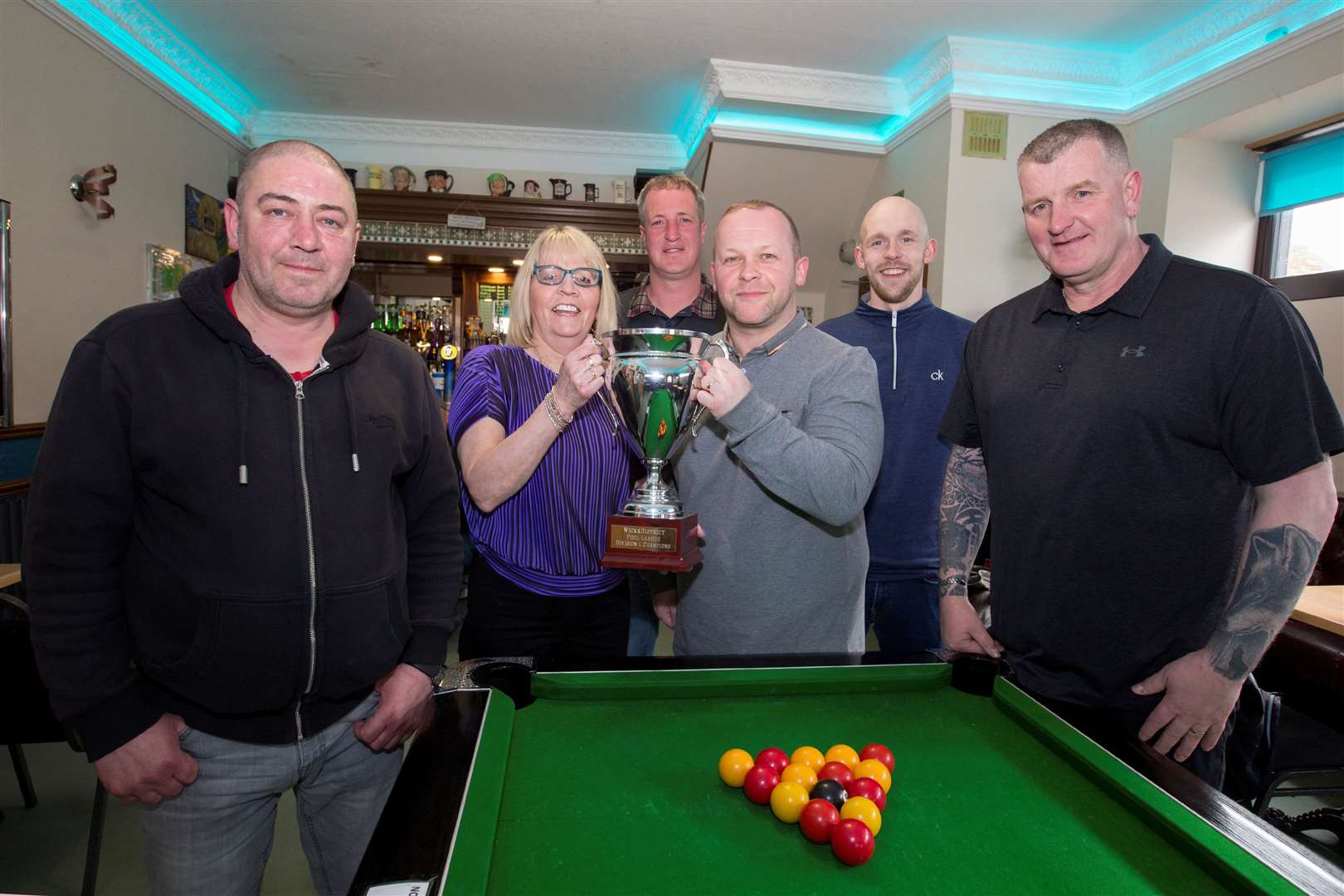 Crown Bar owner Lynda Donn handing over the pool league trophy to team captain Colin Banks, while looking on are (from left) Martin Hill, Alan Stewart, Kevin Cameron and Tam Mulraine. Picture: Robert MacDonald / Northern Studios