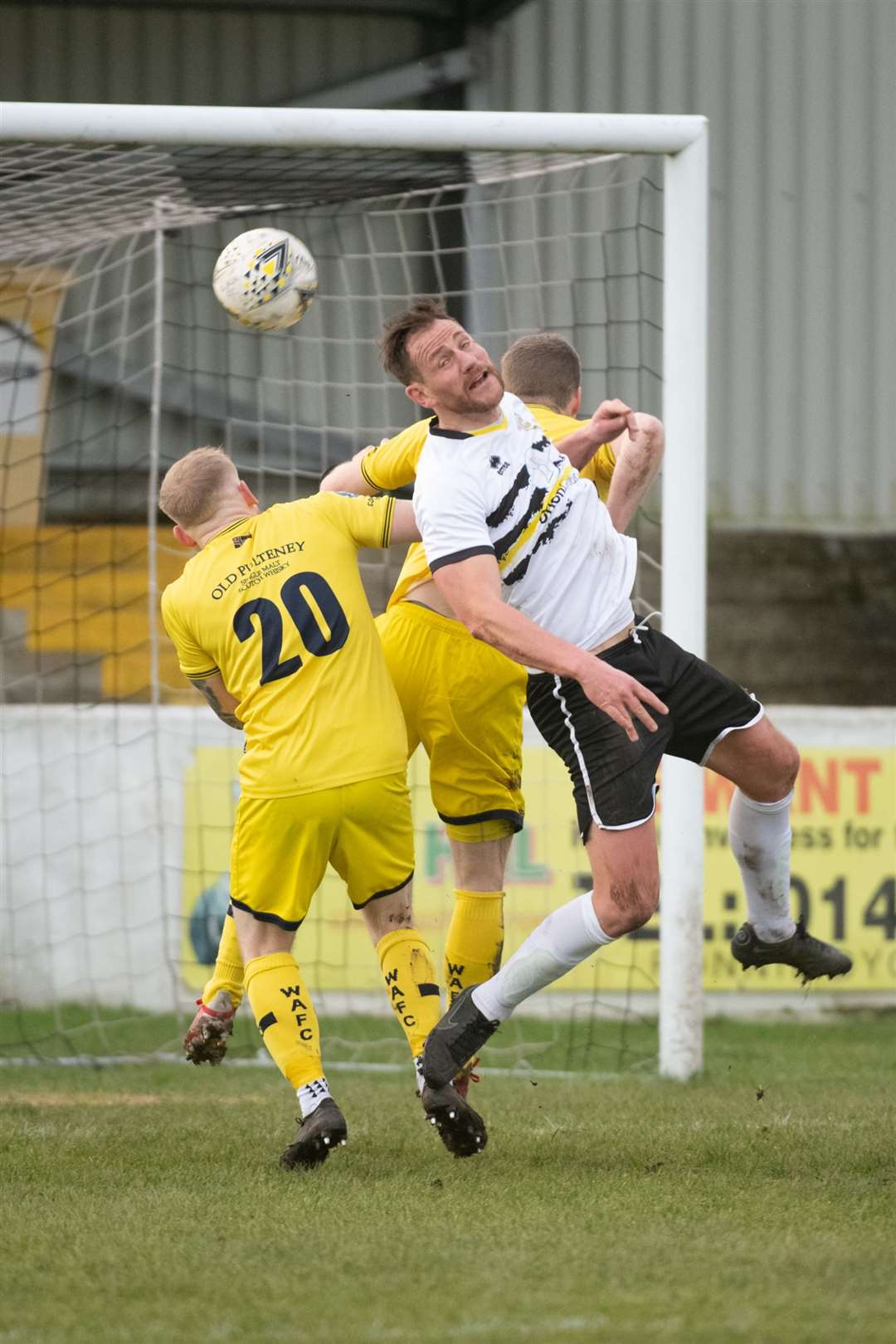 Clach's Gary Warren stretches for a high ball with Alan Hughes in close attendance. Picture: Callum Mackay