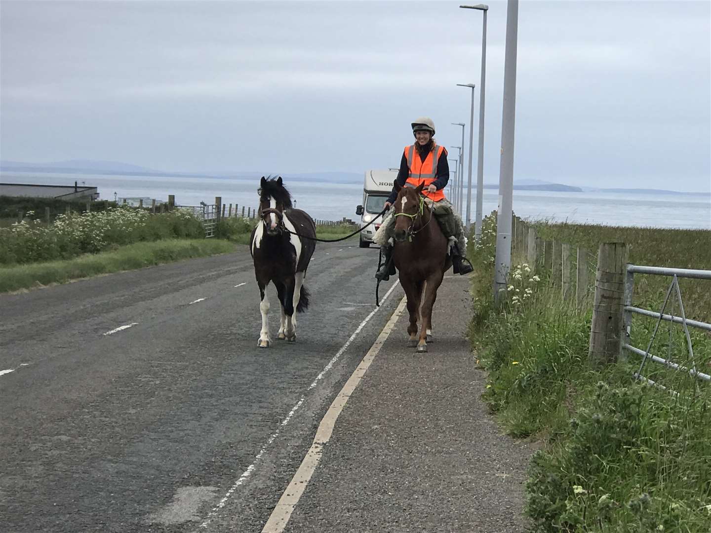 Elsa swapped to her hard hat and hi-vis waistcoat as took to the road, riding Rosie and leading Summer along towards the Seaview Hotel at John O'Groats, before taking the back roads to Lyth.