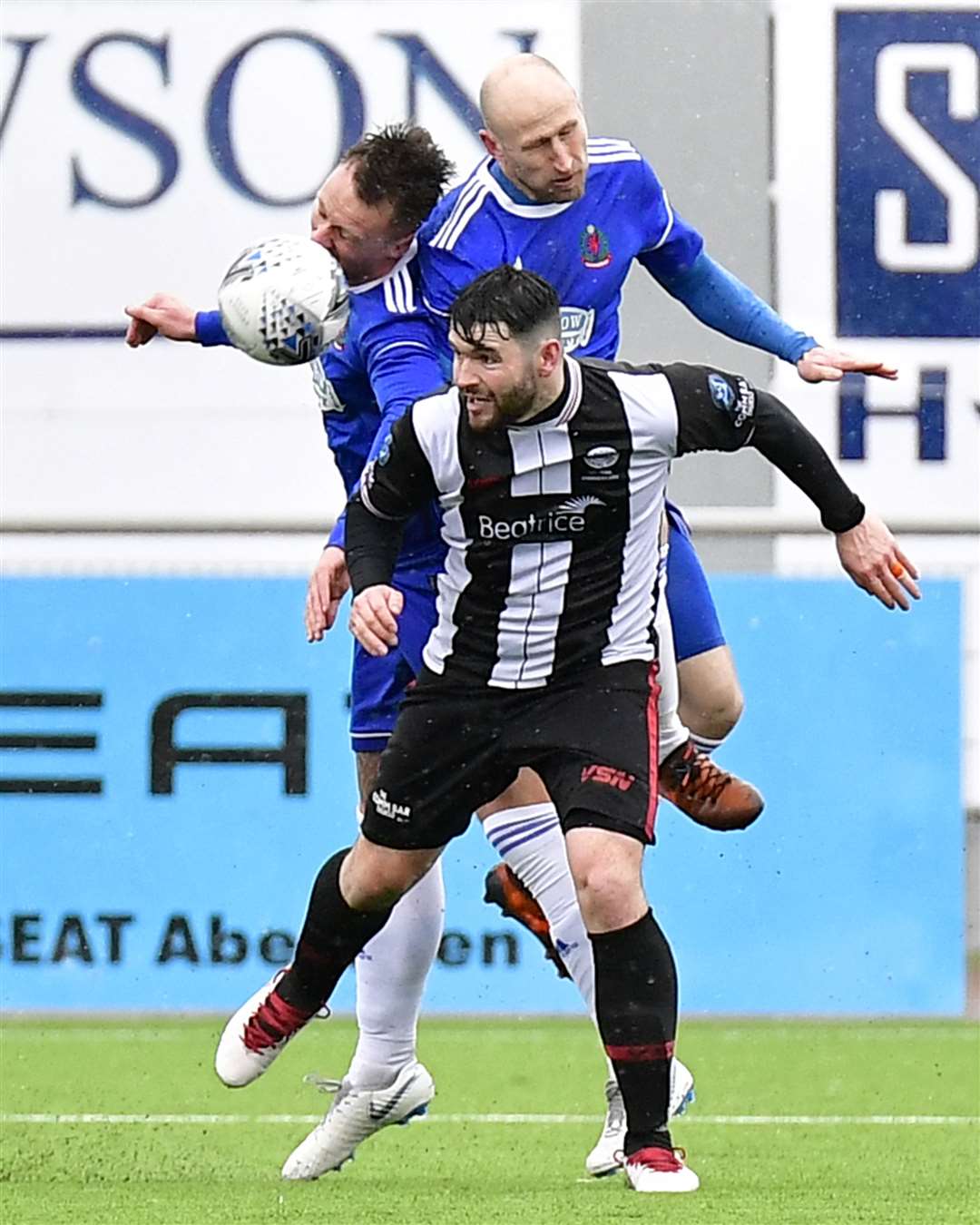 Wick's Sam Mackay heads the ball forward under pressure from Cove's Alan Redford and Ryan Strachan. Picture: Mel Roger