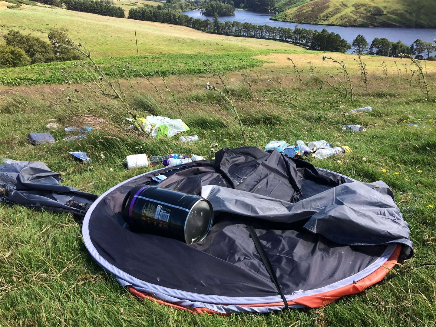 A tent and other debris left behind by irresponsible campers in the Highlands.