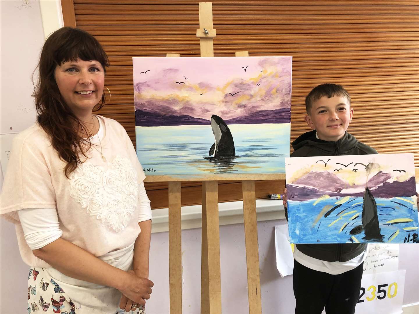 Visiting artist Lisa Weller and primary seven pupil Nathan Pope with their orca paintings.