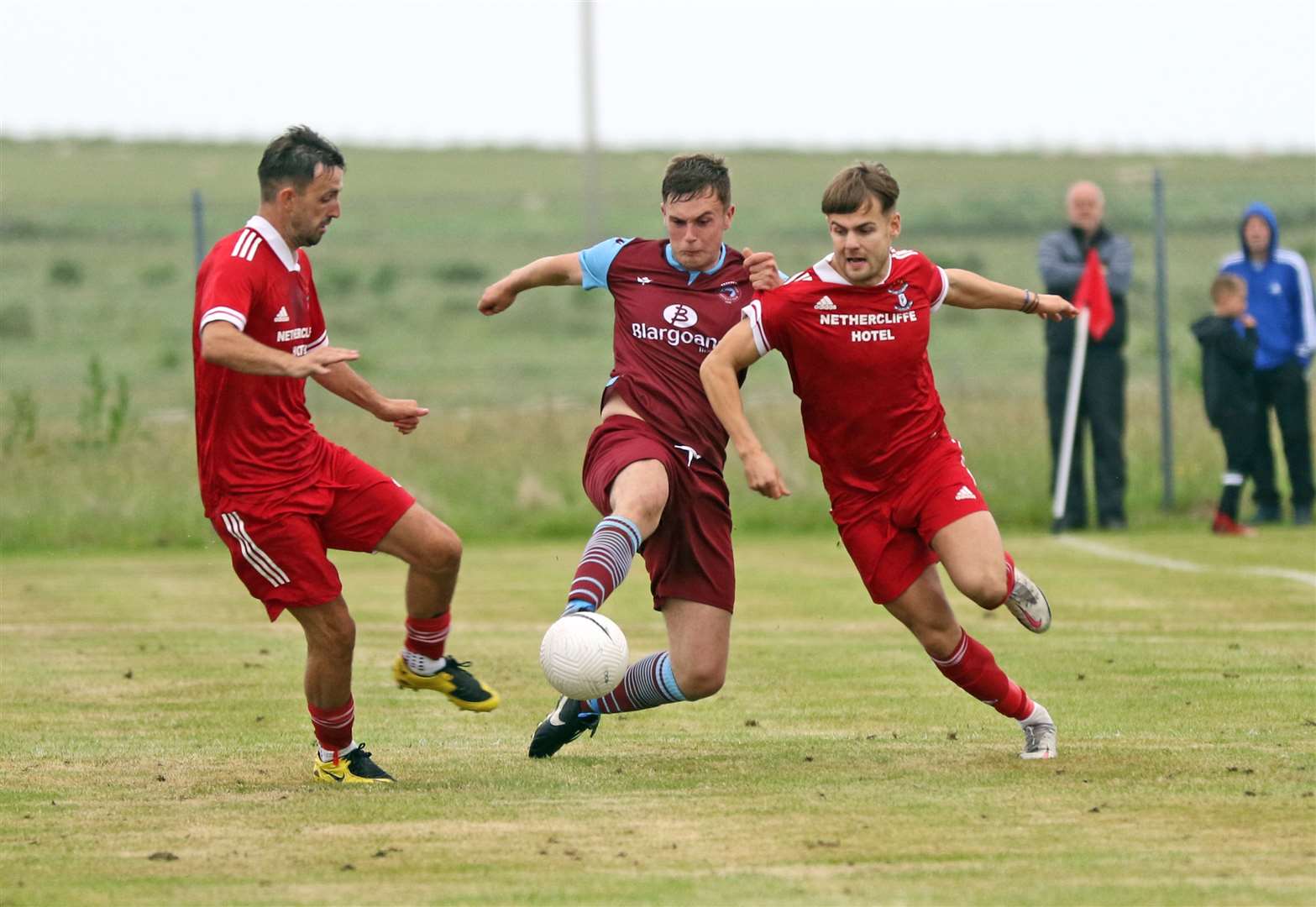 Conor Trueman sandwiched between Graham MacNab and Jonah Martens during Pentland United's semi-final victory over Groats. Picture: James Gunn