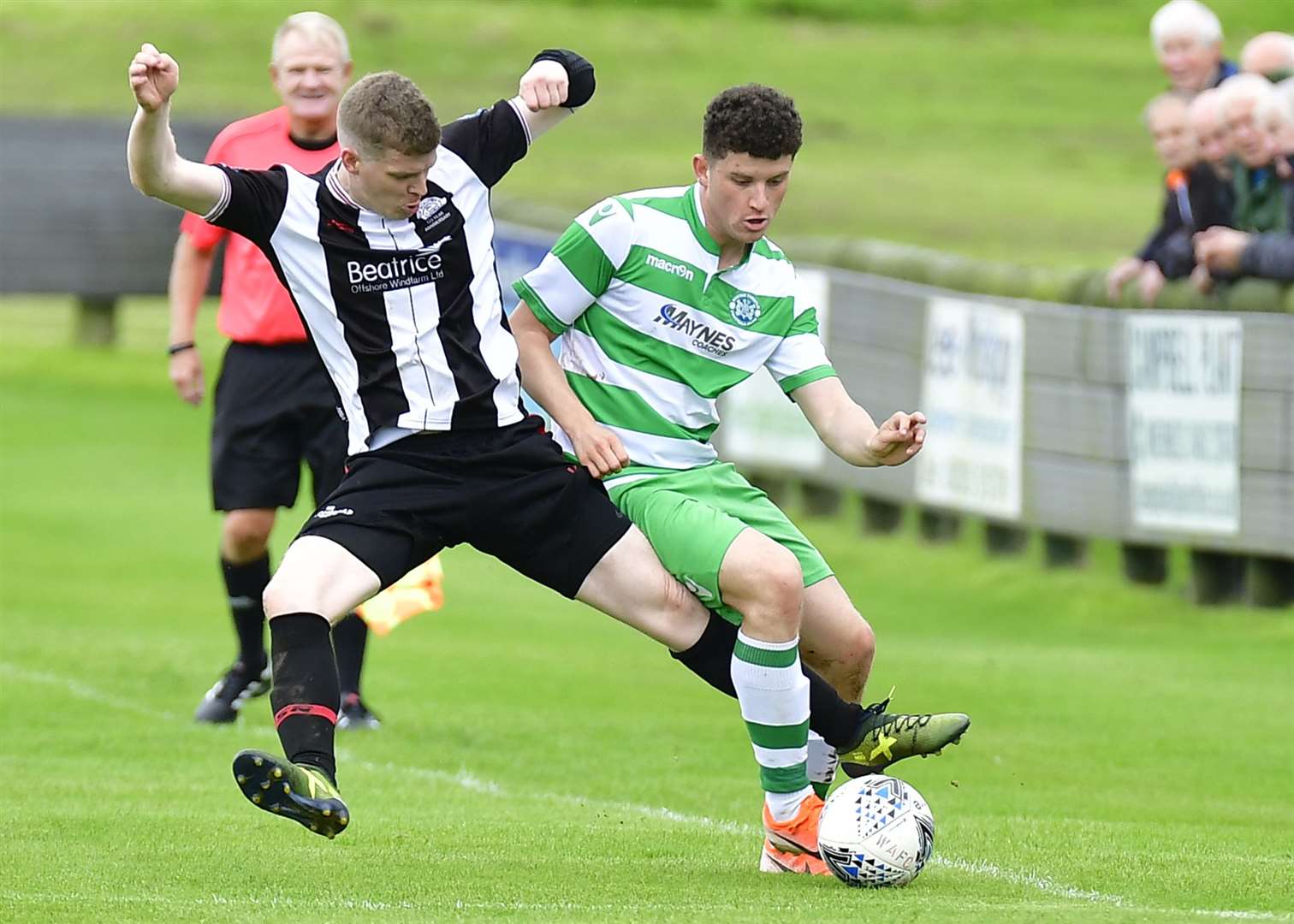 Wick's Ross Allan challenges Buckie's Sam Robertson. Picture: Mel Roger