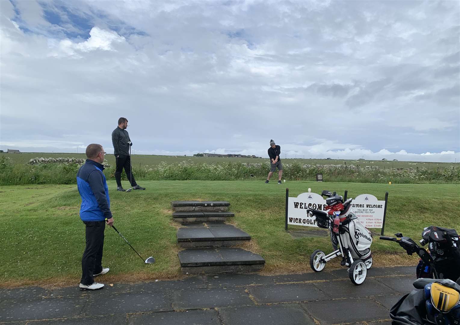 Wick Golf Club’s Stewart Ross on the tee with Graeme MacKay and Sanders Harper waiting their turn when golfers were allowed to play in threes last summer. Picture: Wick Golf Club