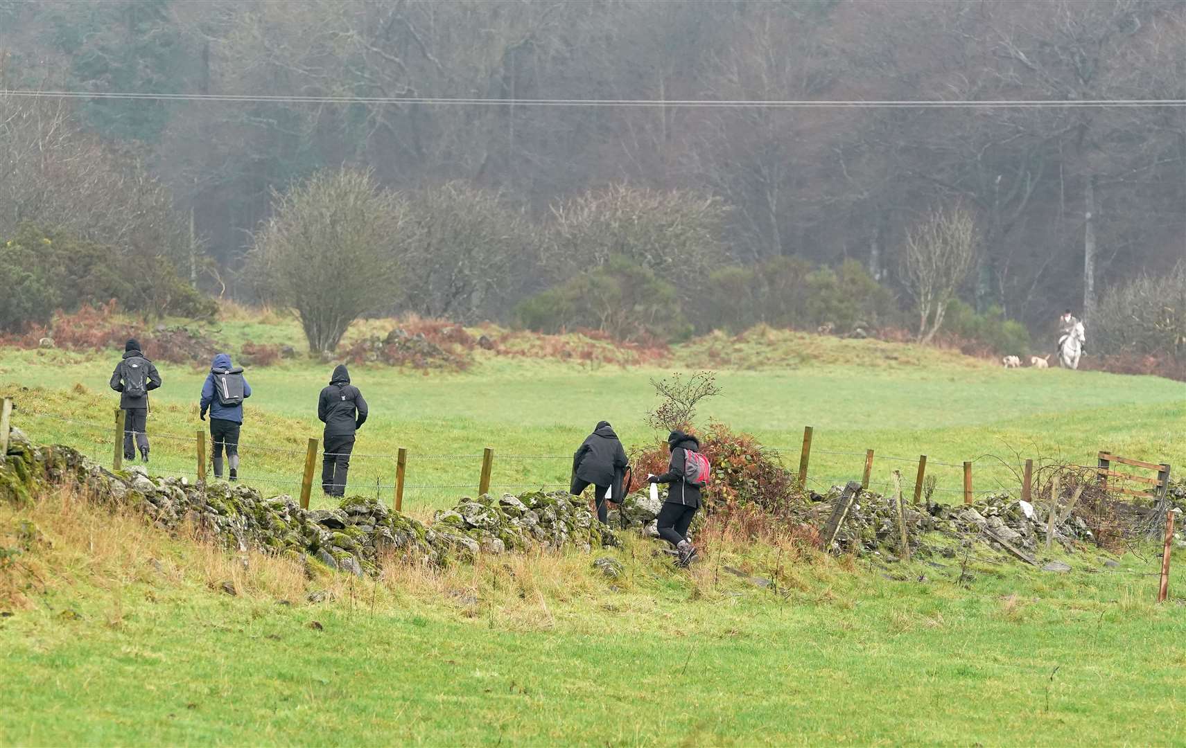 Saboteurs holding spray bottles follow riders and hounds as they take part in the annual hunt (Andrew Milligan/PA)