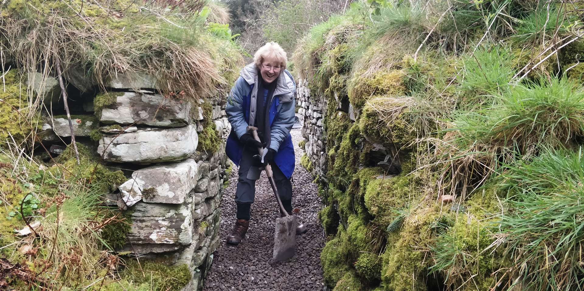 One of the volunteers clearing a path into the broch.
