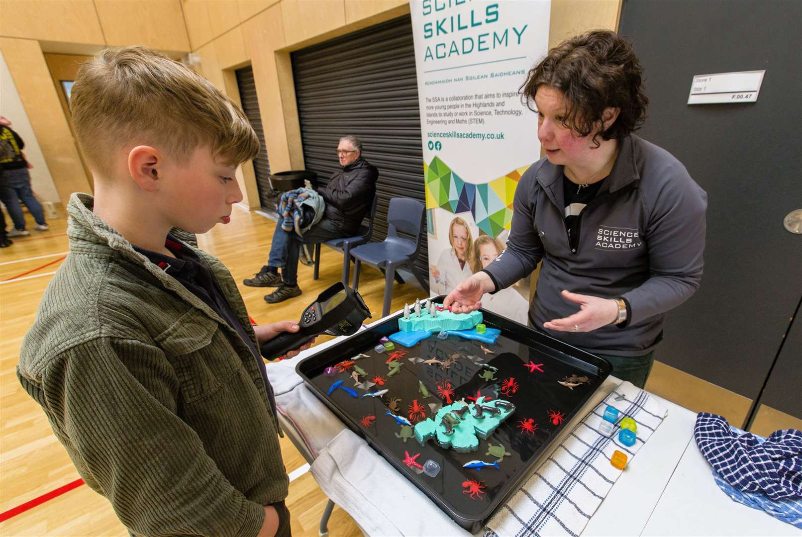 Camden Hollick from Thurso visits the Science Skills Academy stand where Aileen Simmonite from the Thurso Newton Room was on hand to answer his questions. Photo: Robert MacDonald/Northern Studios