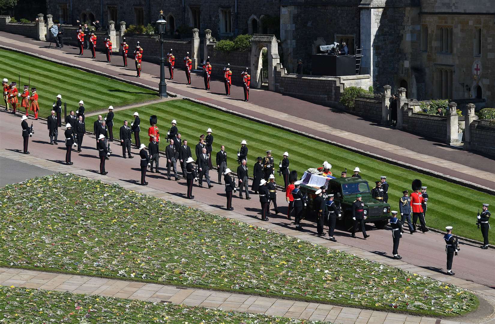 The Duke of Edinburgh’s coffin is carried on the purpose-built Land Rover Defender followed by members of the royal family outside St George’s Chapel, Windsor Castle (Justin Tallis/PA)