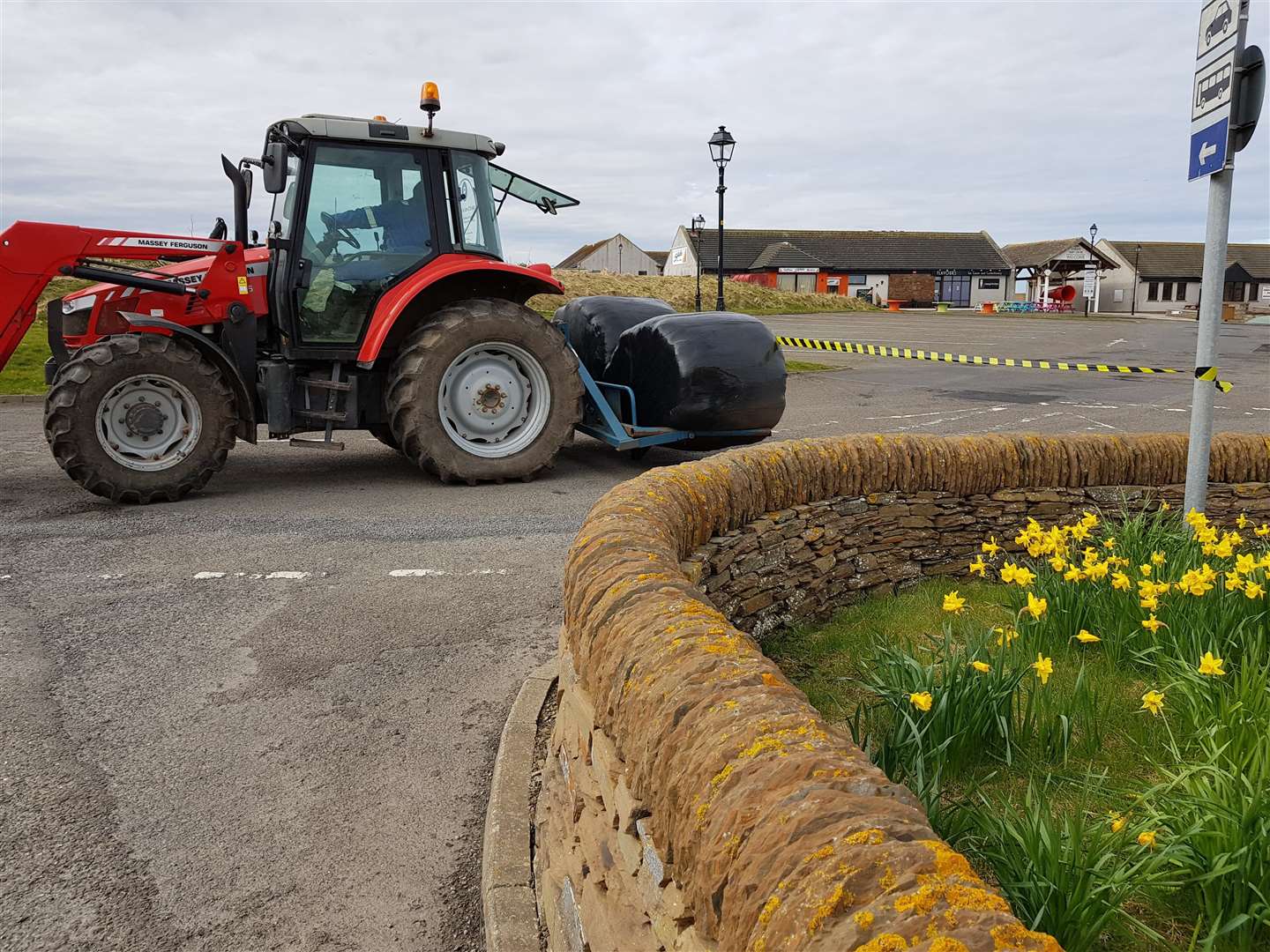 William Steven on the tractor closing off the car park at John O'Groats.