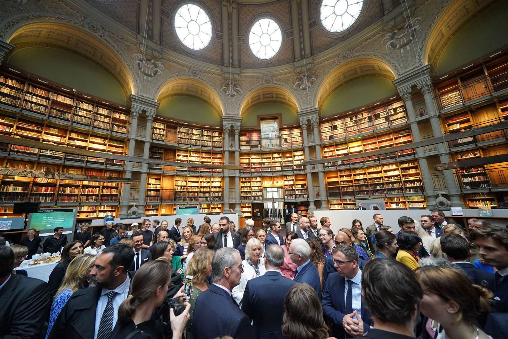 Camilla, centre in white, speaks with guests at the Bibliotheque Nationale de France in Paris (Yui Mok/PA)