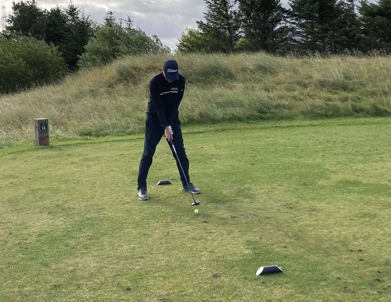 Gavin Gunn teeing off at the 16th hole.