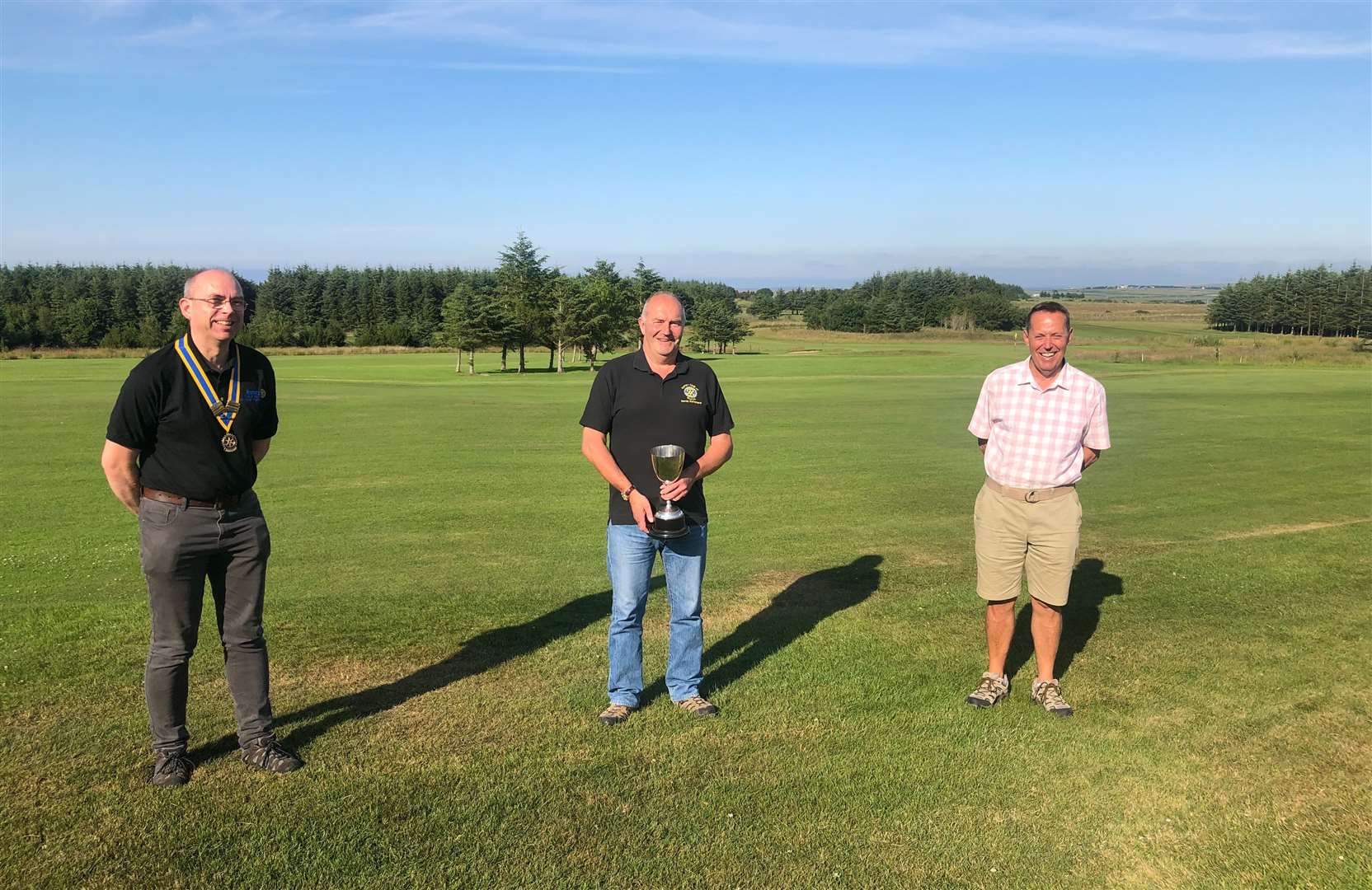 Rotary Open winner Sandy Sutherland with Thurso Rotary president Chris Pearson (left) and club captain Alan Coghill (right).