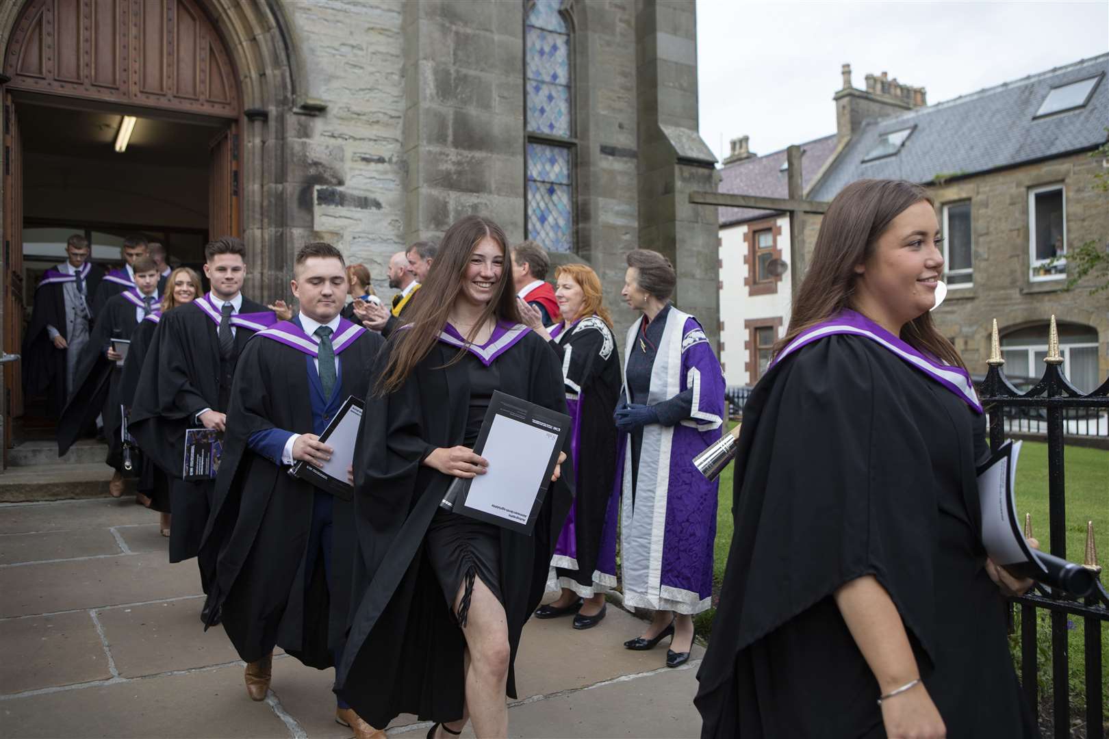 Graduates leaving St Peter's and St Andrew's Church after the ceremony.