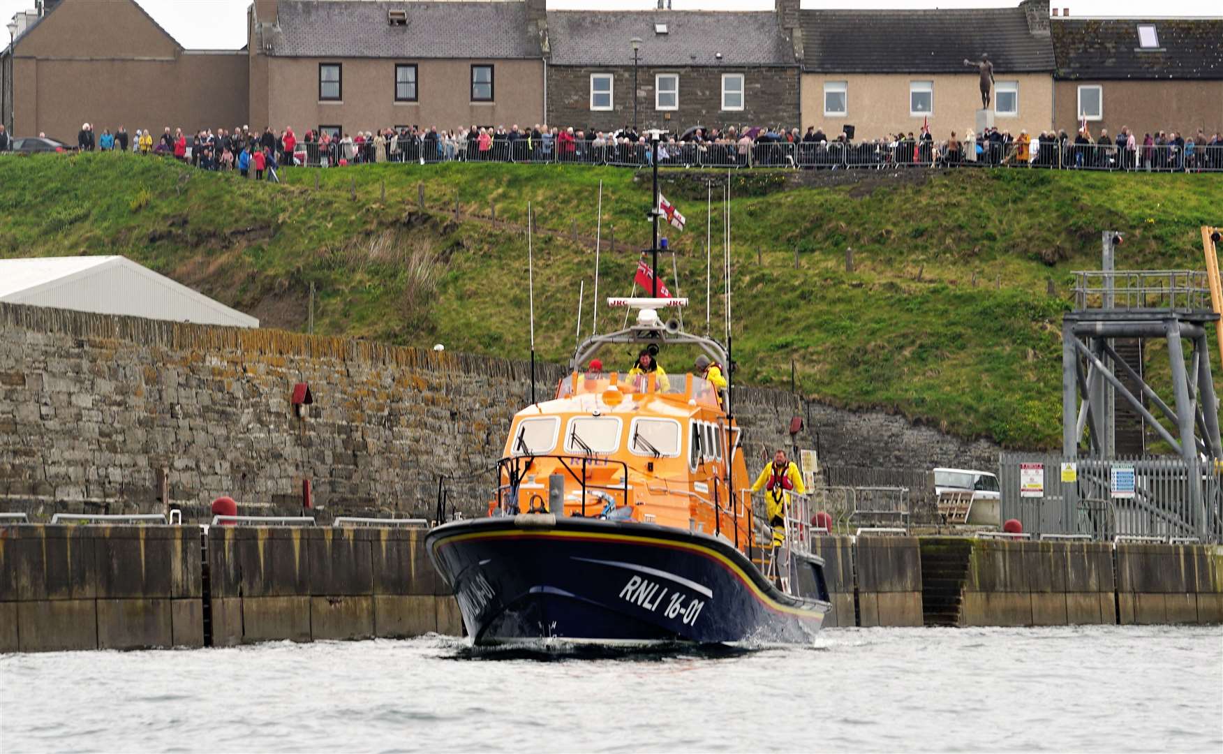 Longhope lifeboat making its way out to Wick Bay, with crowds lining the Braehead above. Picture: DGS
