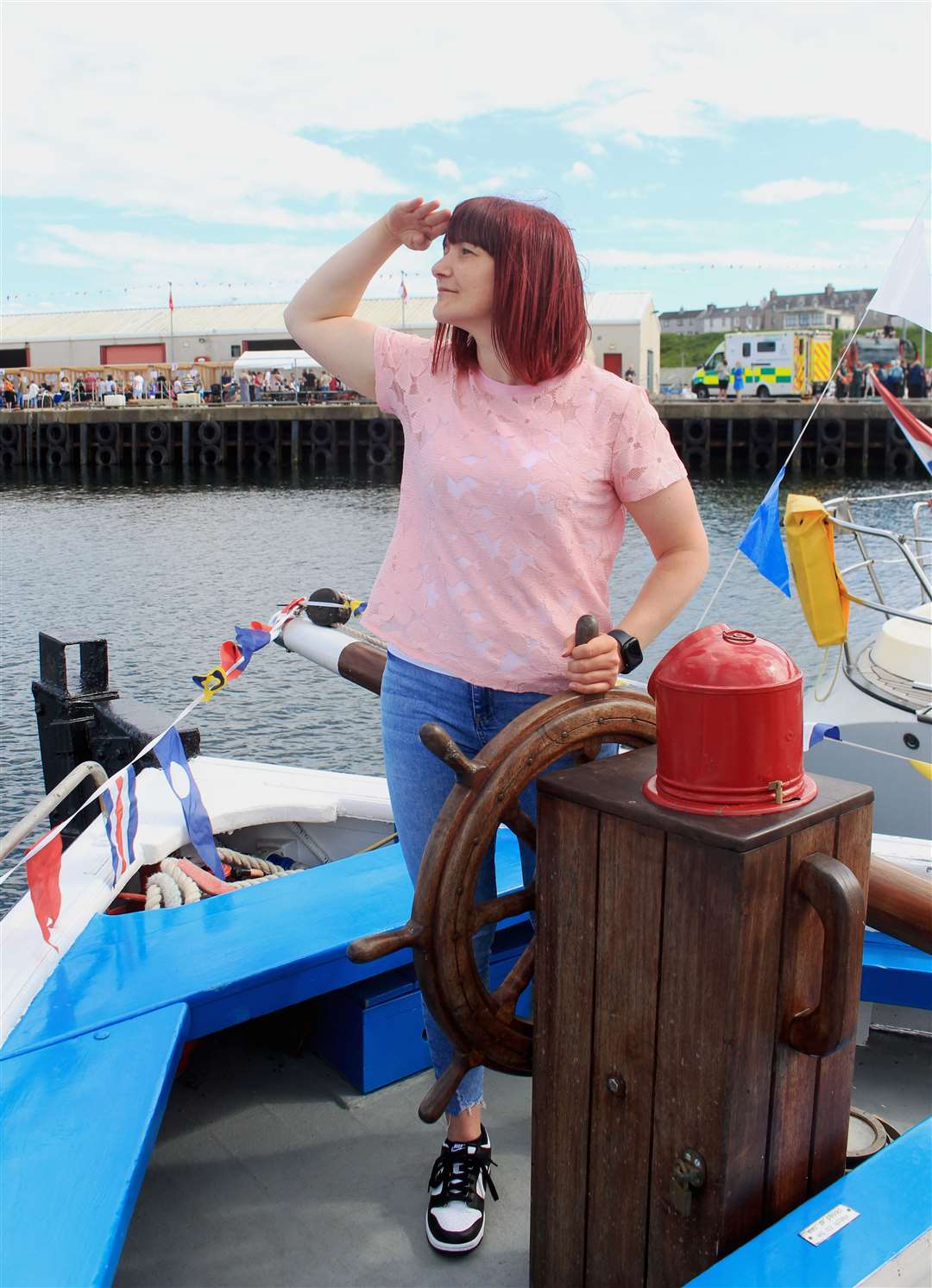 Land ahoy! Lorna Robertson at the helm of the Wick Society's historic boat Isabella Fortuna. Picture: Alan Hendry