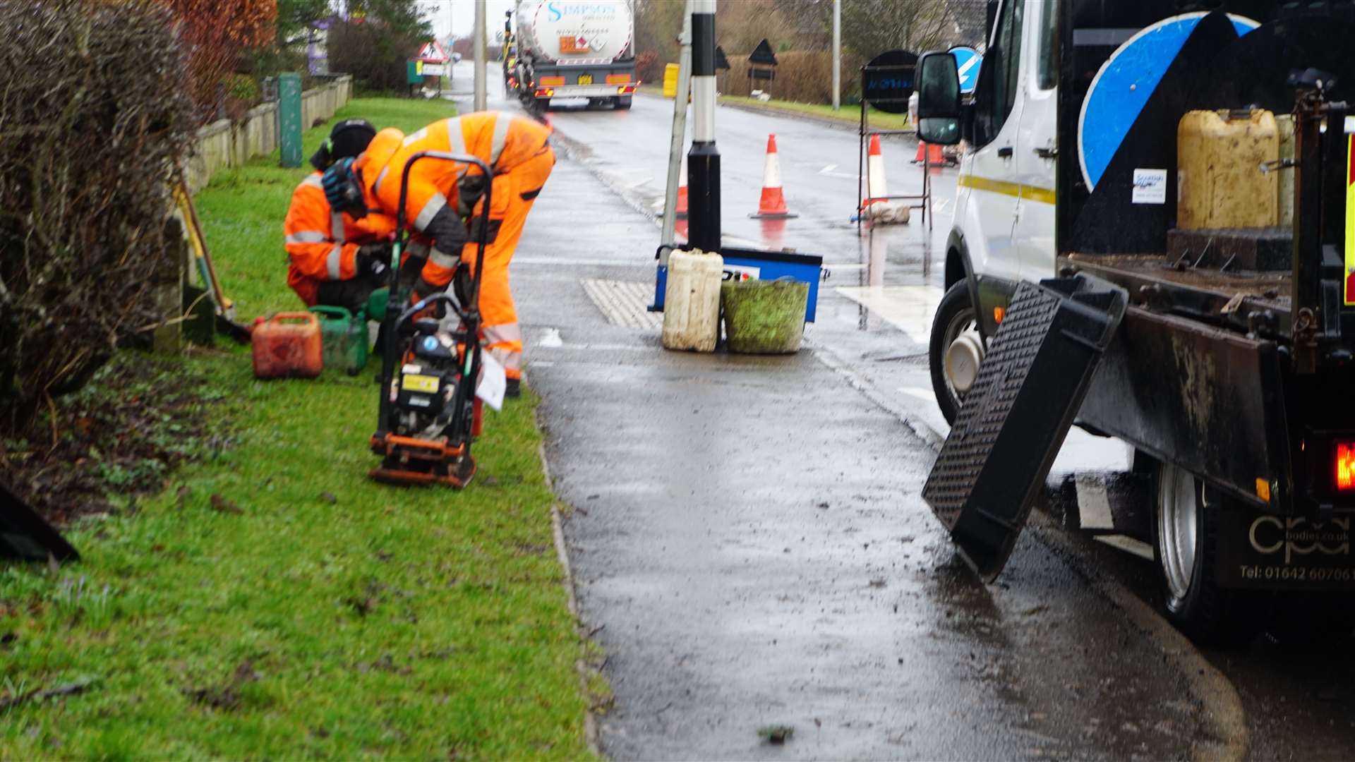 Workmen prepare to fix the long-running problem of the noisy manhole cover. Picture: DGS