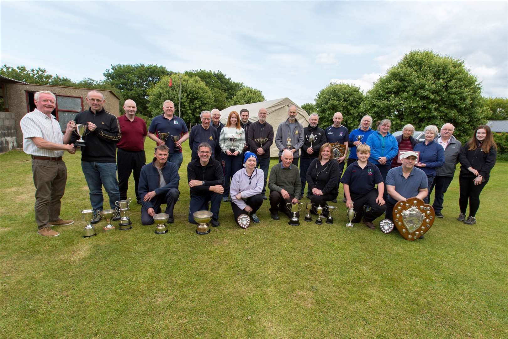 At the end of Caithness Small Bore Rifle Association’s annual open shoot, county indoor and outdoor champion David Simpson, from Wick Old Stagers, receives one of his trophies from John Sinclair (left), who over the years has been a stalwart of shooting in the county. Looking on are some of the other trophy-winners and competitors who took part in the event at Wick Old Stagers’ outdoor range. Picture: Robert MacDonald/Northern Studios