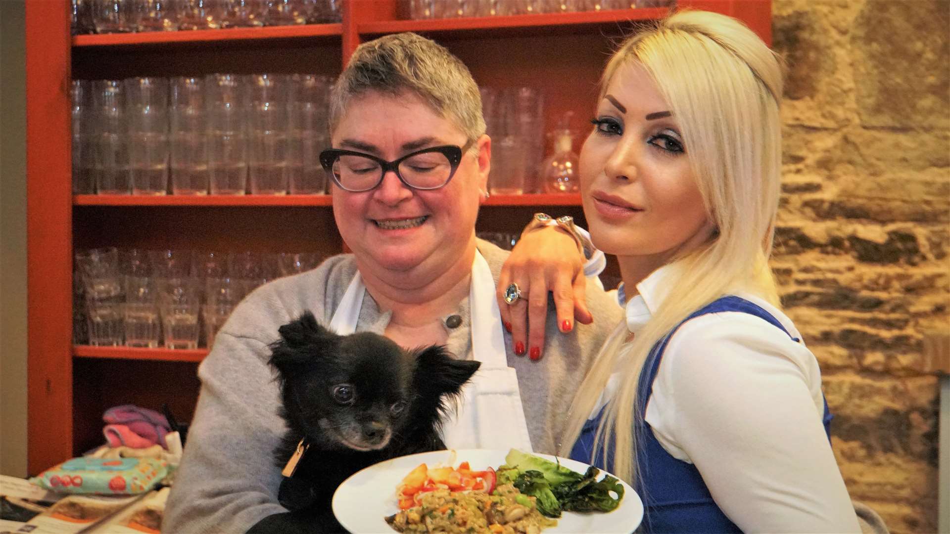 Louis the chihuahua has his eyes firmly on the tasty vegan dish Natalie is holding.