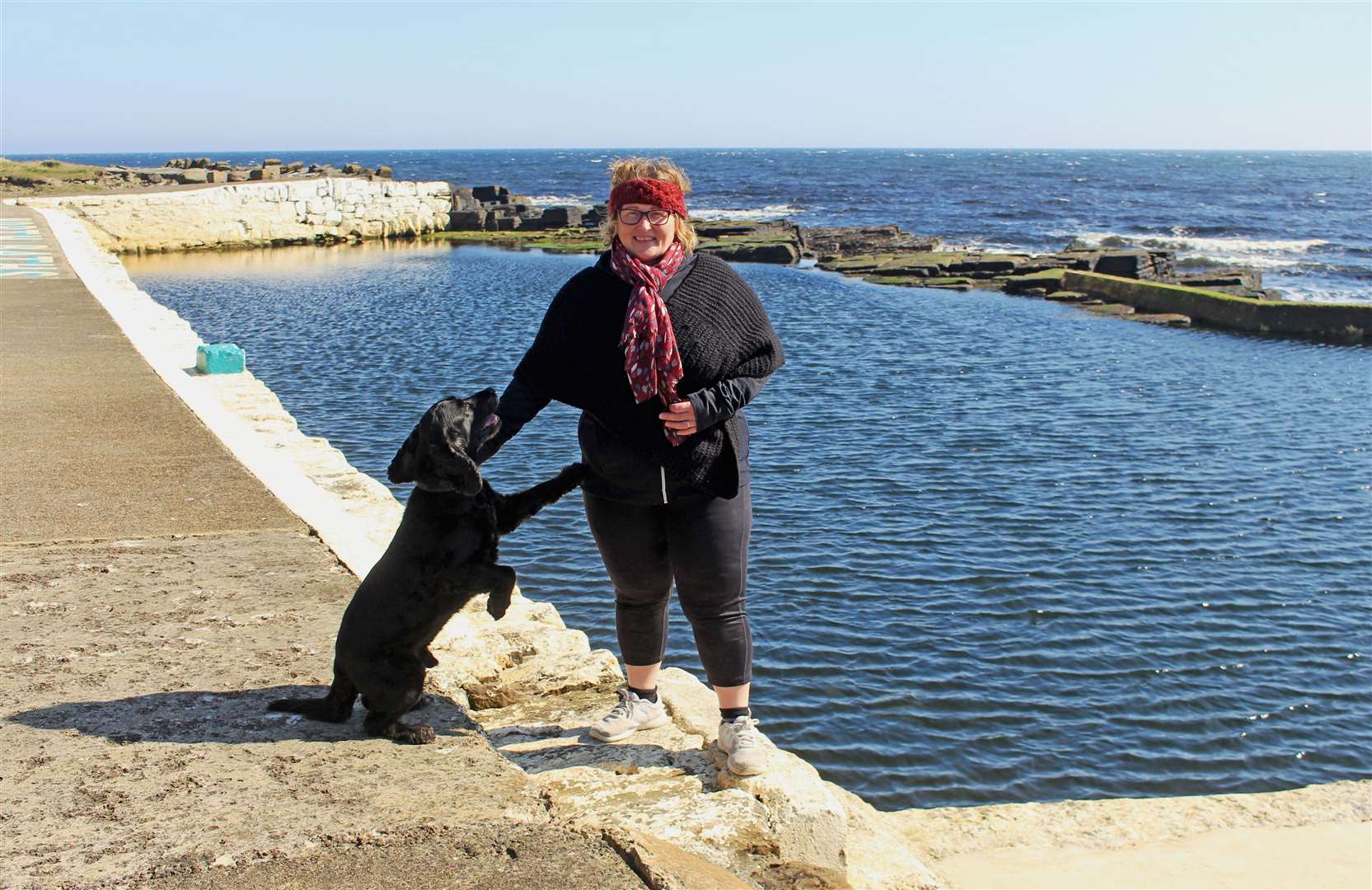 Patty Coghill with Alfie the dog at the North Baths this week. Picture: Alan Hendry