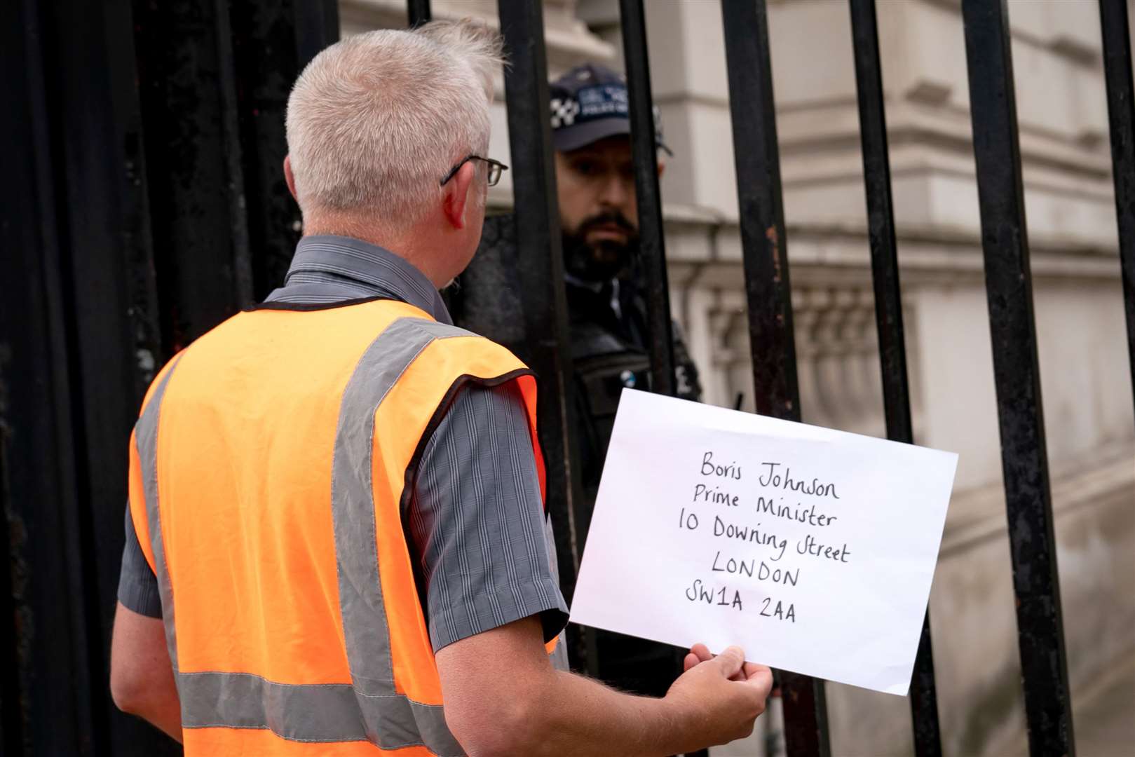 A member of Insulate Britain attempts to hand in a letter for Prime Minister Boris Johnson at 10 Downing Street (Aaron Chown/PA