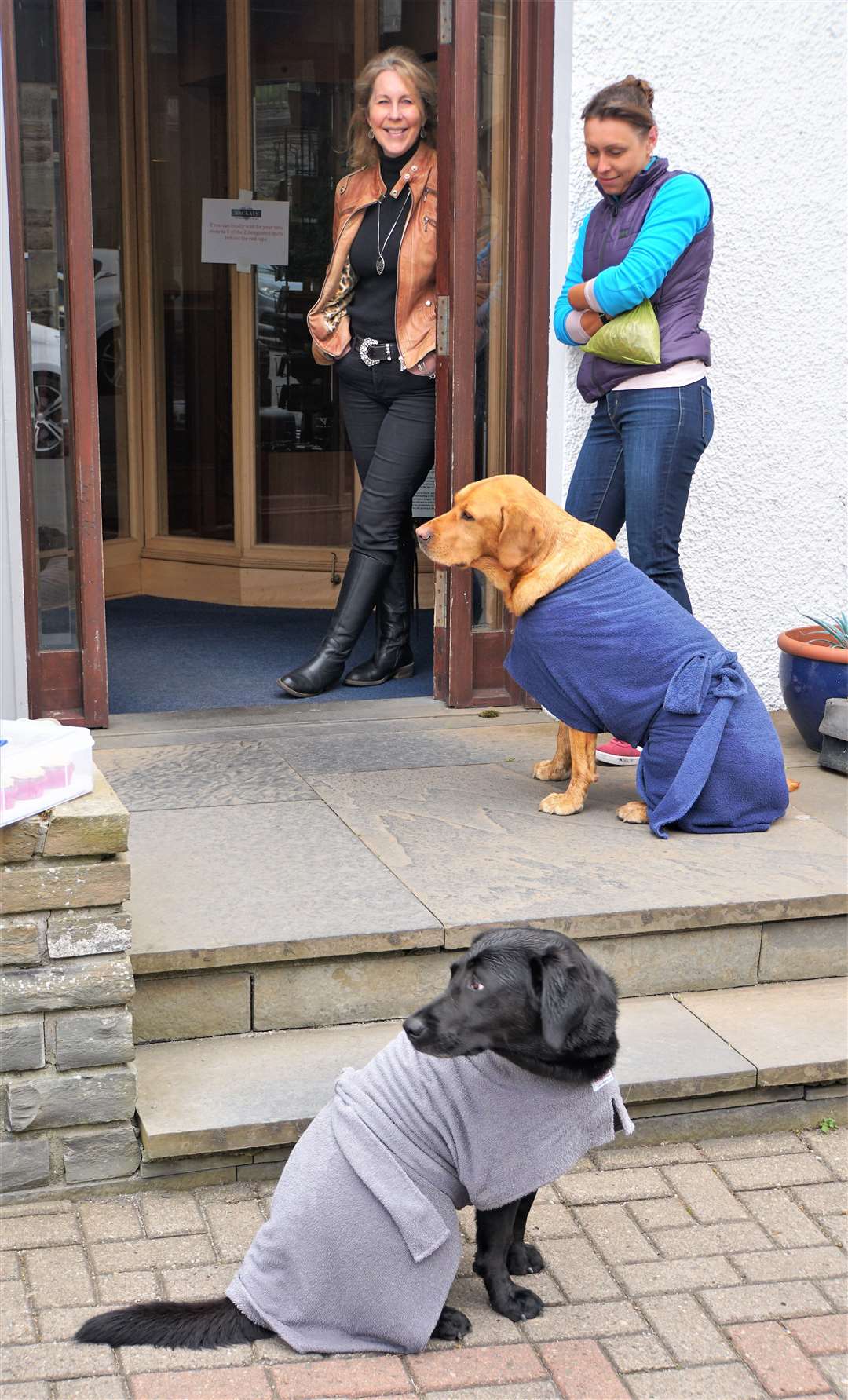 Ellie Lamont, left, with her daughter Jennifer at the front of Mackays Hotel with their dogs. Picture: DGS