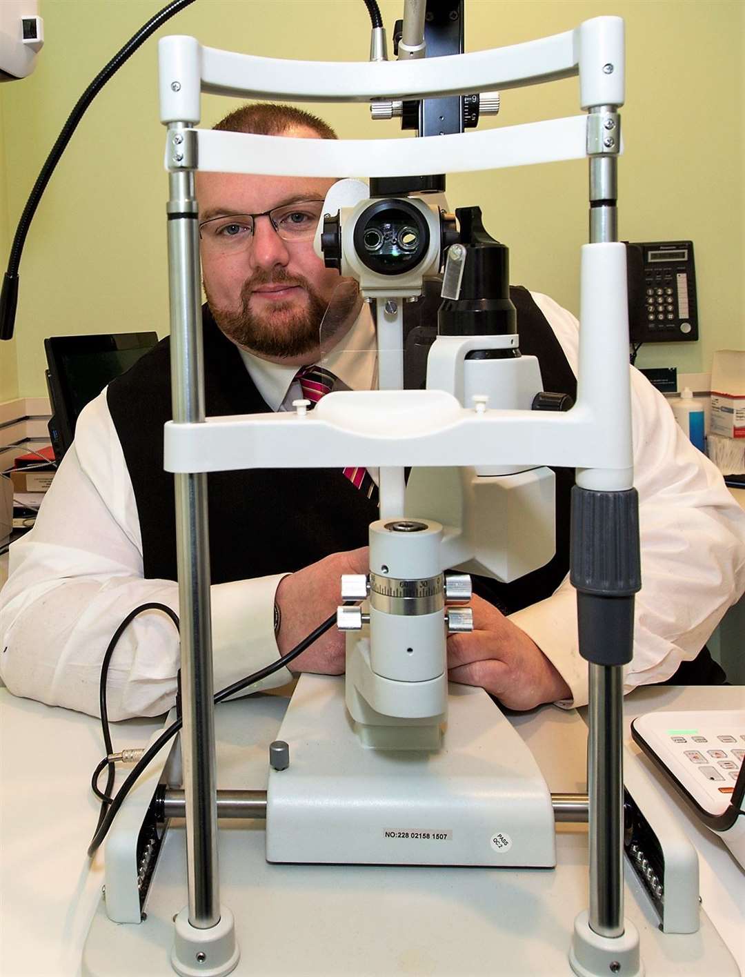 Ian with specialist eye equipment at Specsavers in Wick.