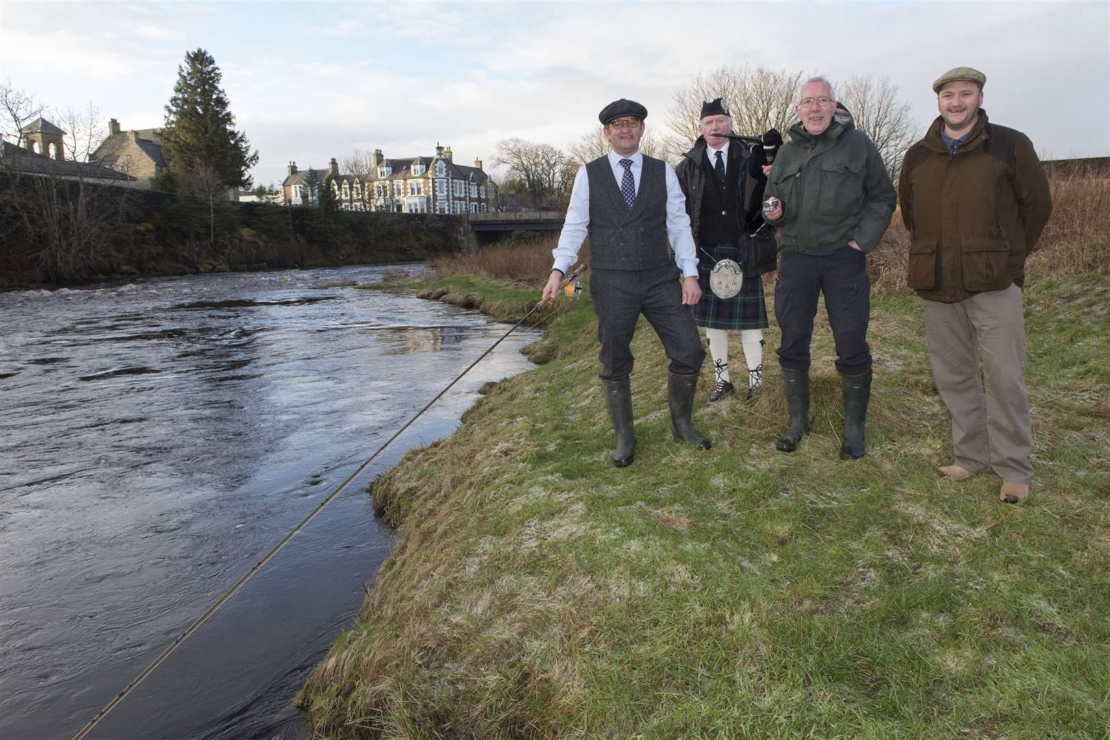 Piper Alasdair Miller with (from left) Richard Medley, who cast the first fly, Alan Youngson, who toasted the river, and senior ghillie Geordie Doull at the opening of the salmon season on Thurso River. Picture: Robert MacDonald / Northern Studios