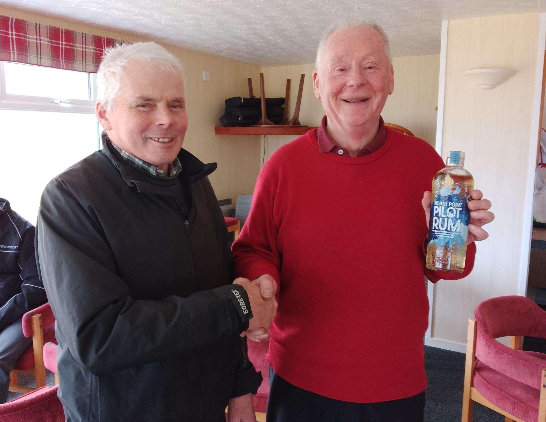Colin Struthers (right), winner of the nearest-the-pin prize in the latest round of the North Point Distillery Senior Stableford competition, receives his prize courtesy of the sponsors from Reay seniors convener Sandy Chisholm.